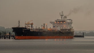 A large boat floating on top of a body of water