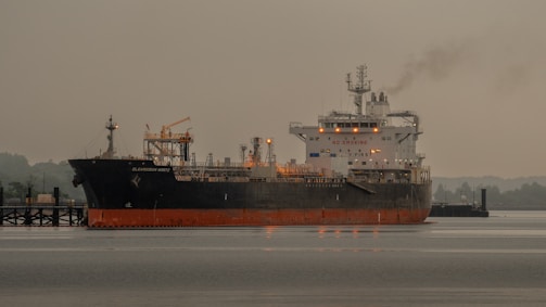A large boat floating on top of a body of water