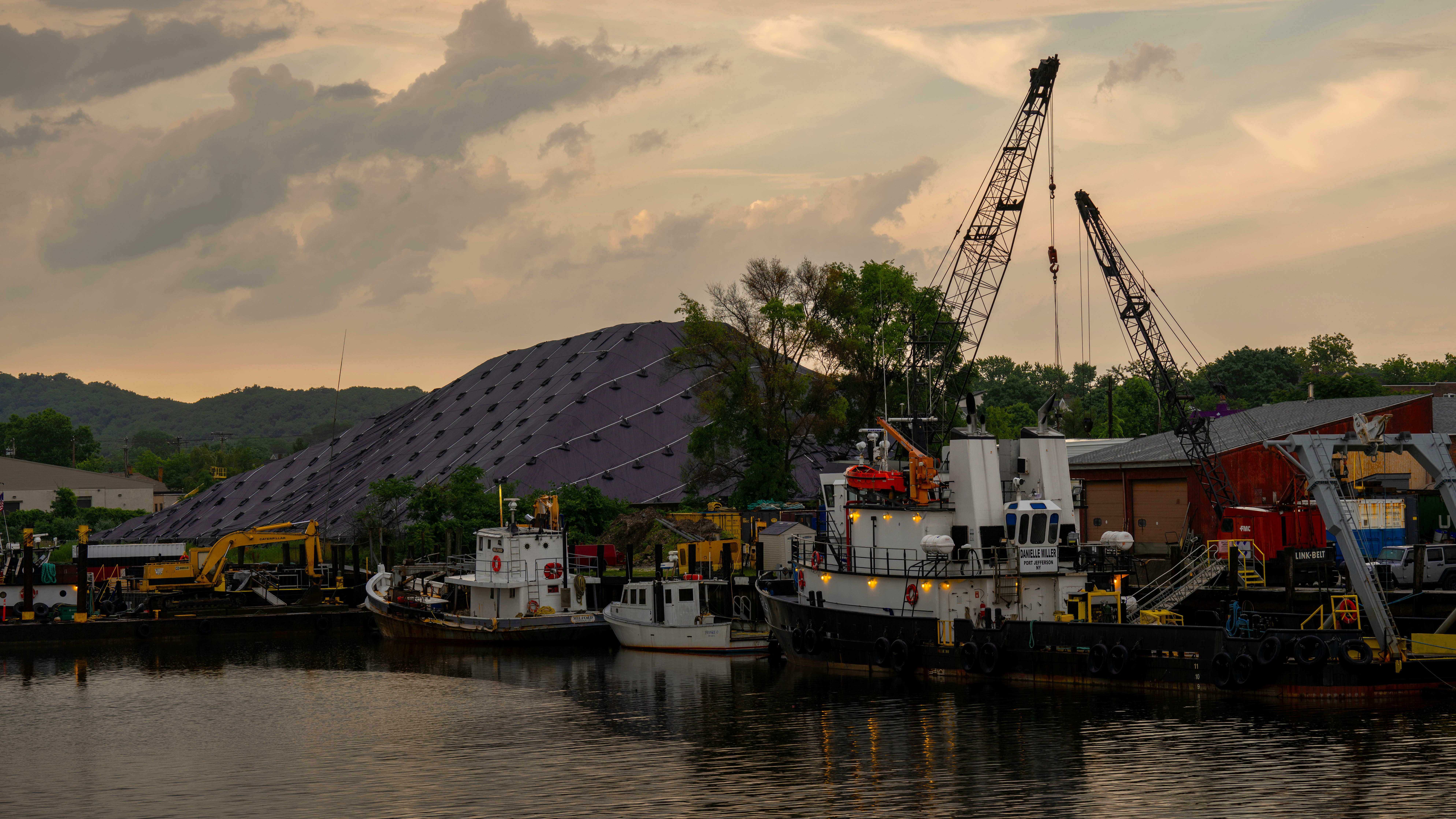 A harbor filled with lots of boats under a cloudy sky