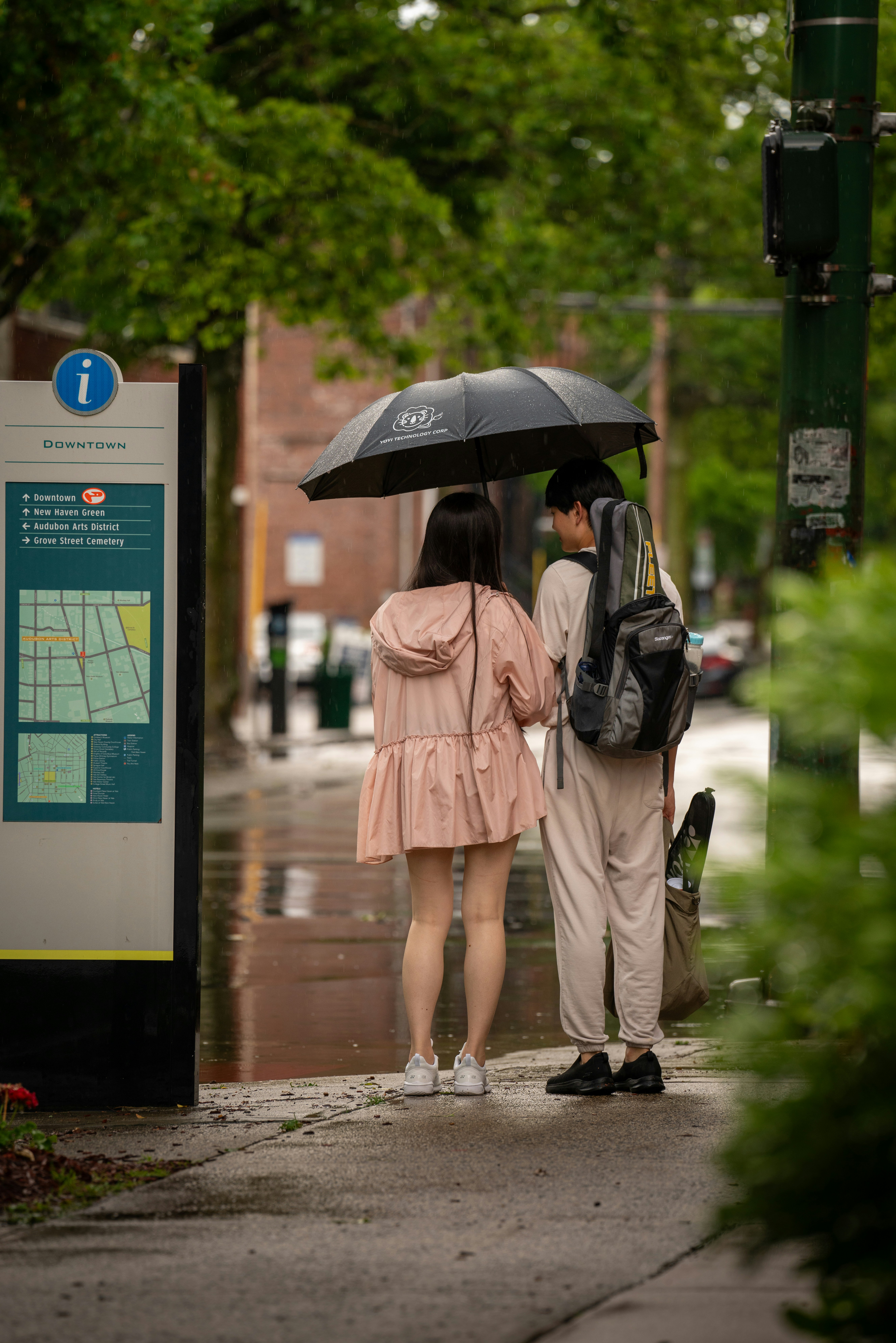 A couple of people that are standing under an umbrella