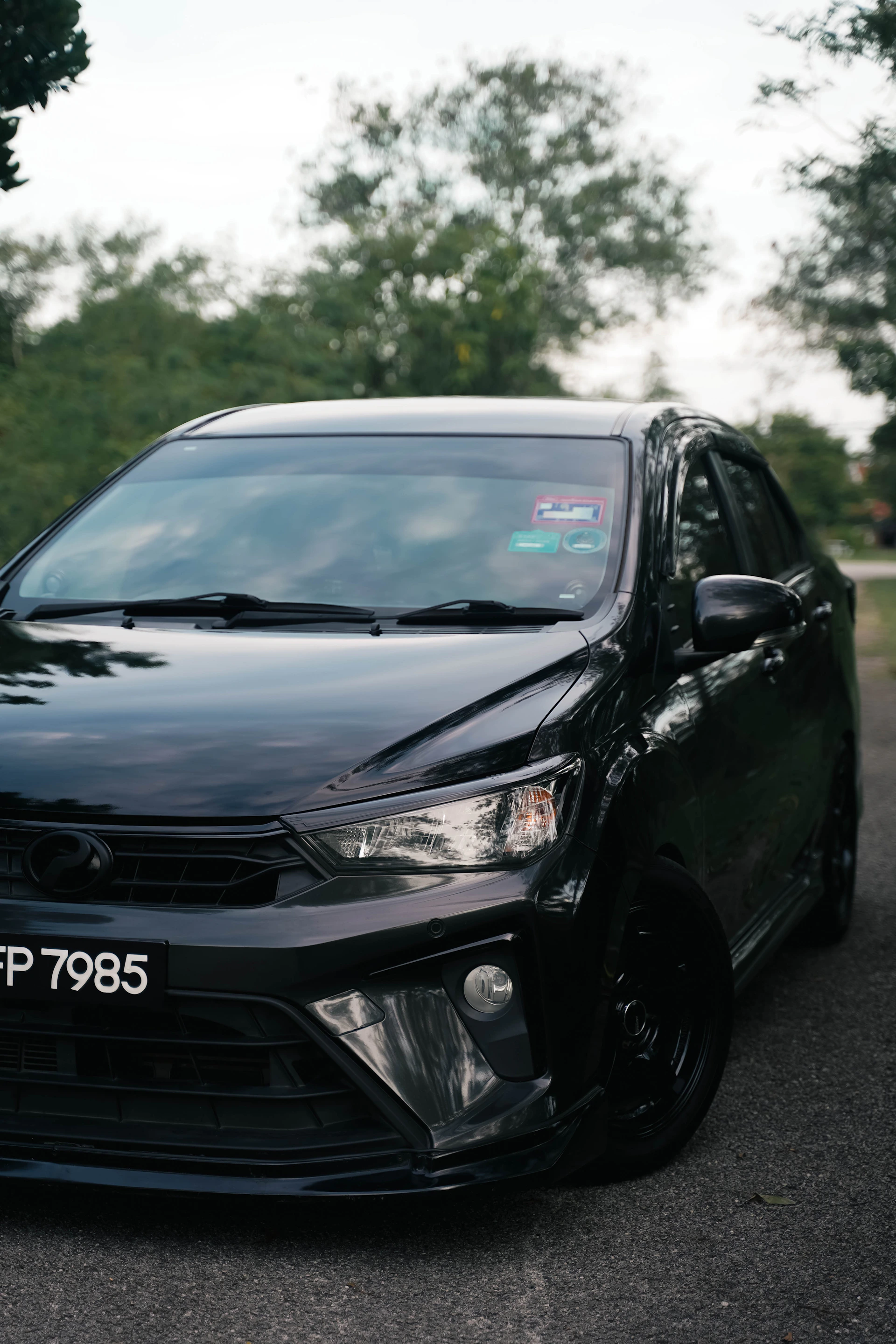 A black car parked on the side of a road