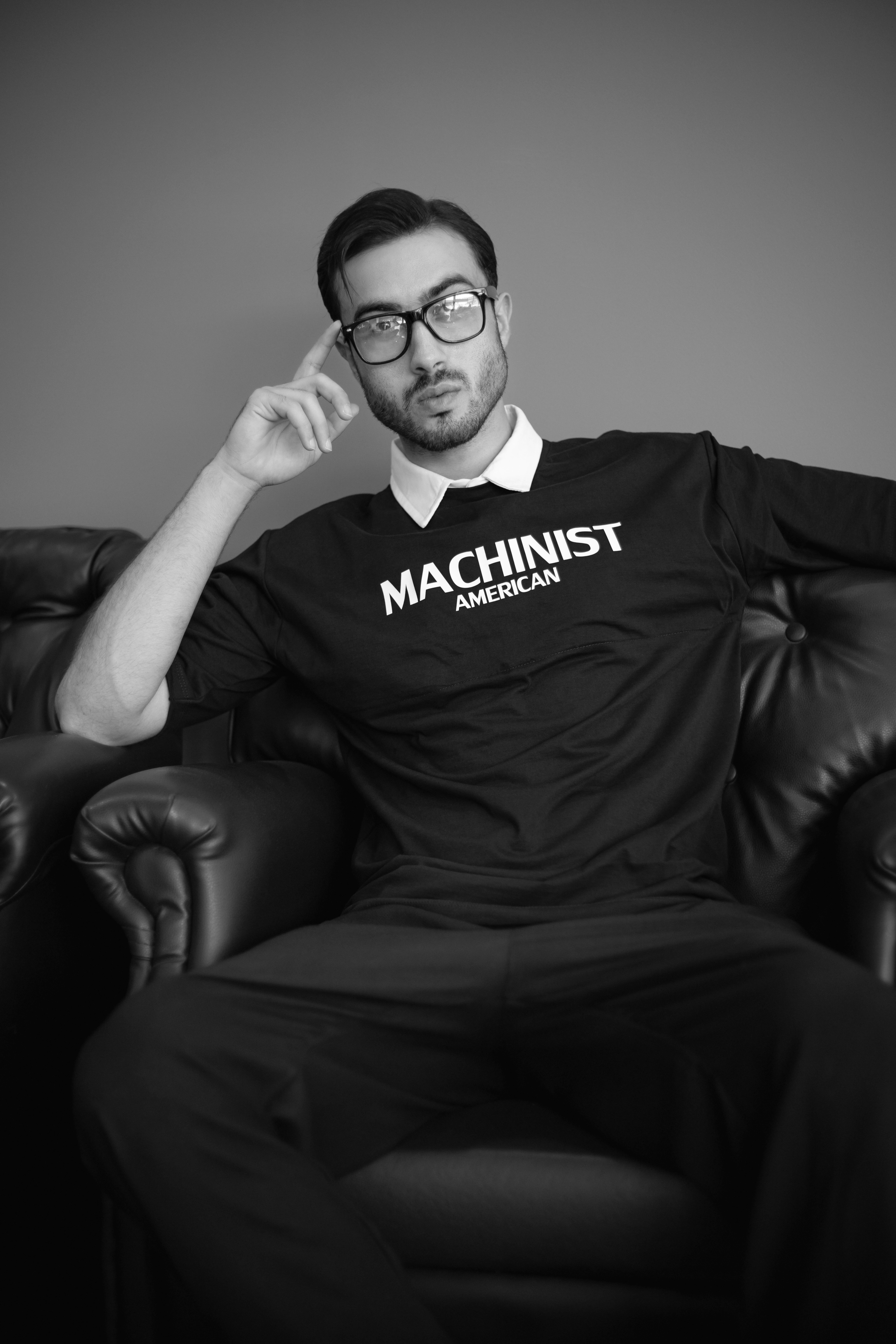A man sitting in a chair wearing a black shirt