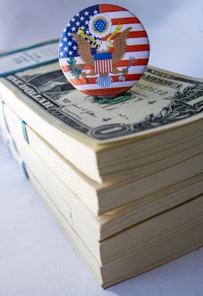 A button on top of a stack of money