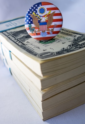 A button on top of a stack of money