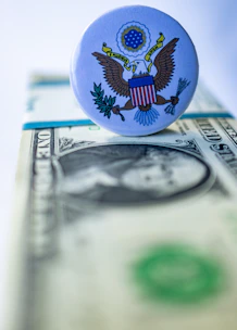 A close up of a button on a dollar bill