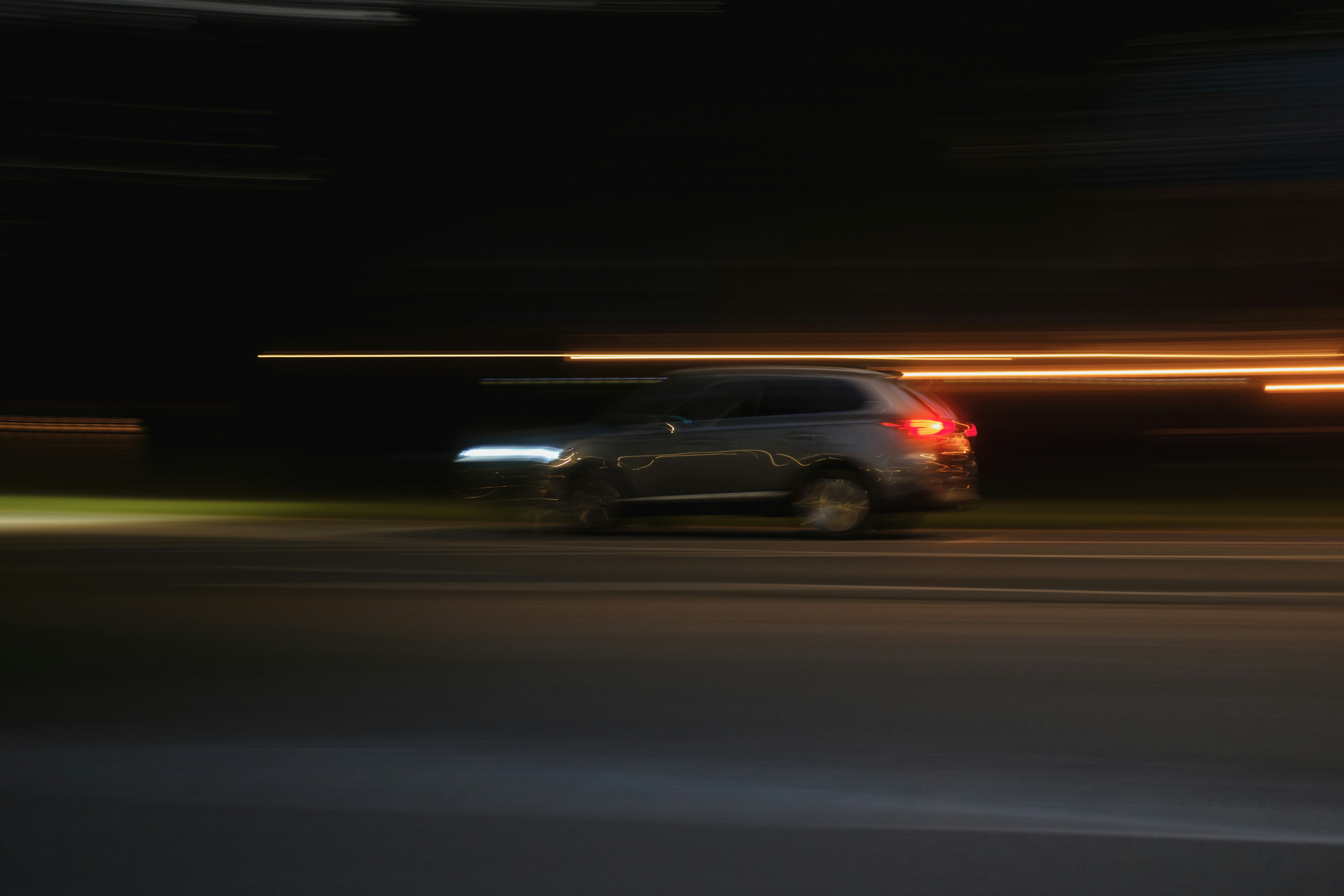 A blurry photo of a car driving down a street