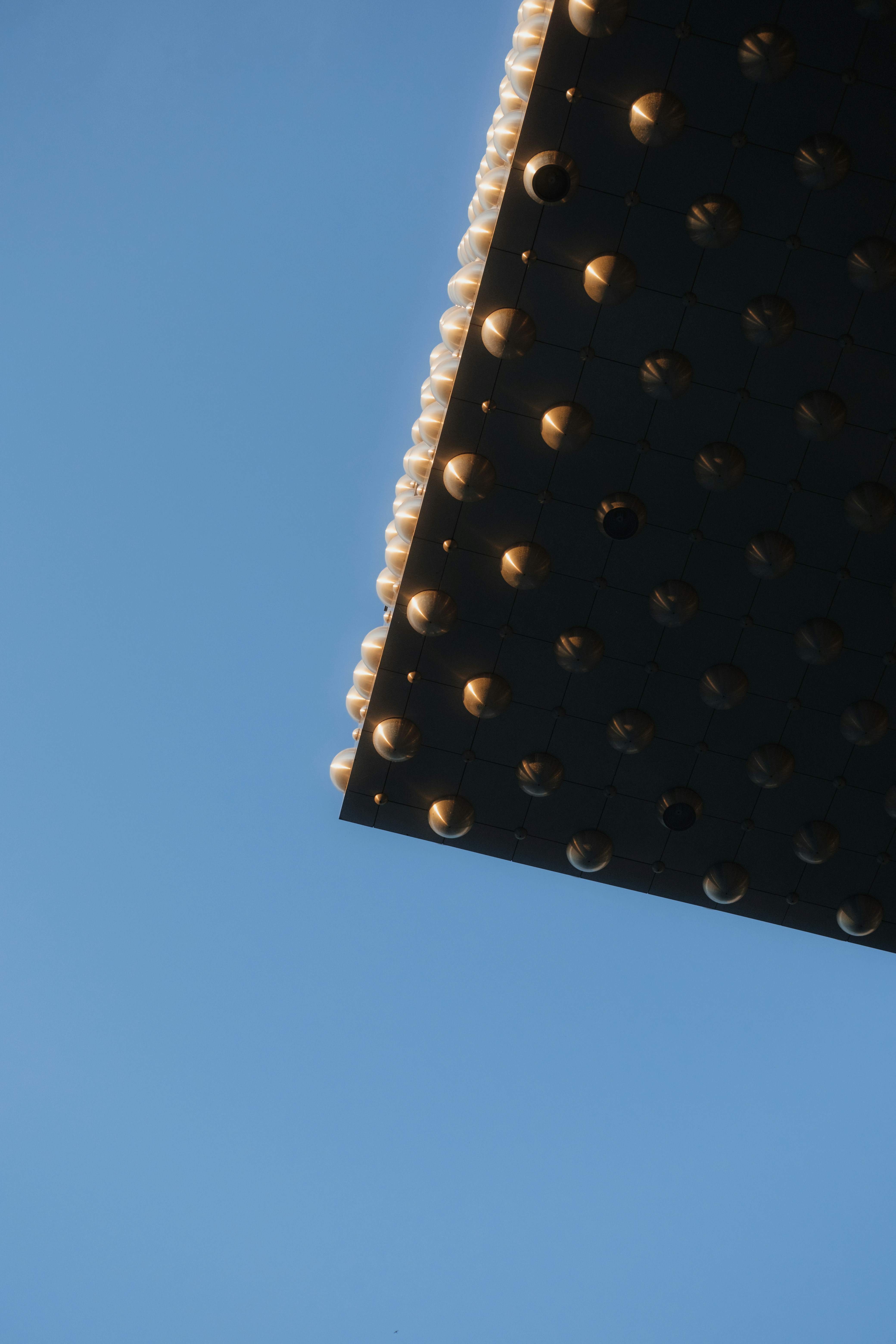 An airplane flying in the air with a blue sky in the background