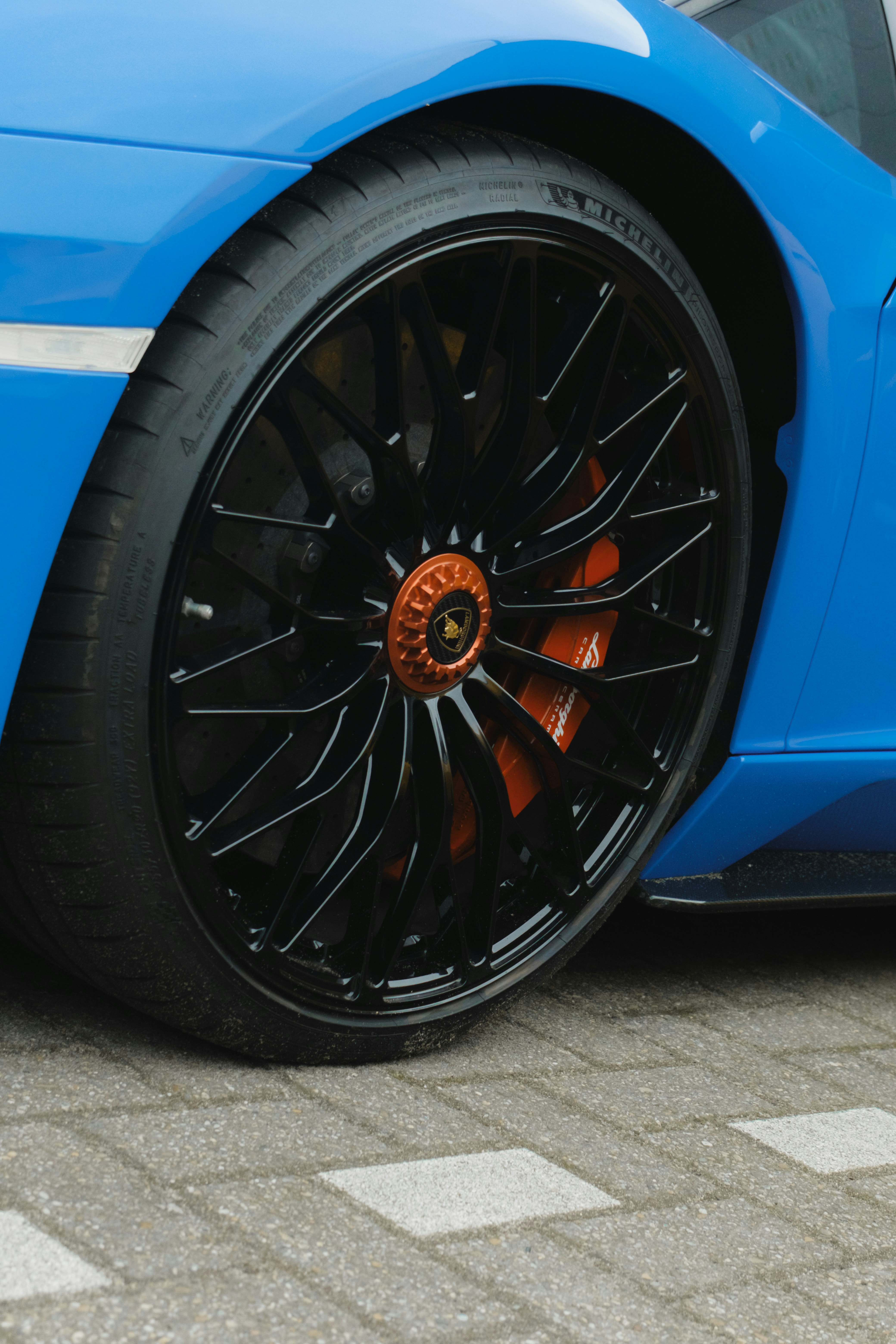 A blue sports car parked on the side of the road