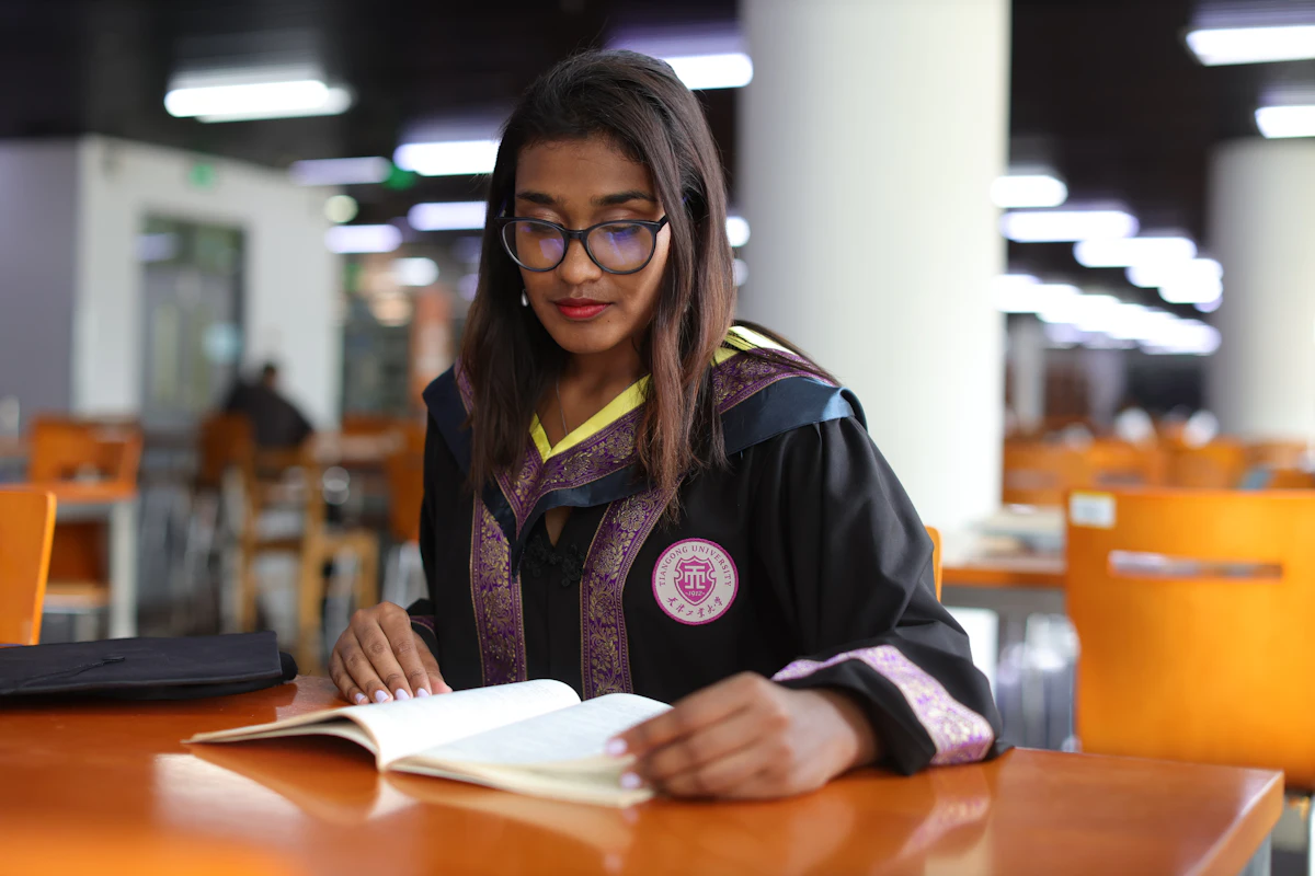 Student working at a table with a laptop