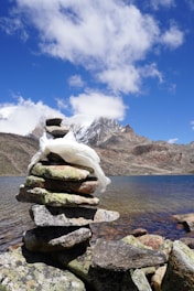 A pile of rocks sitting on top of a lake