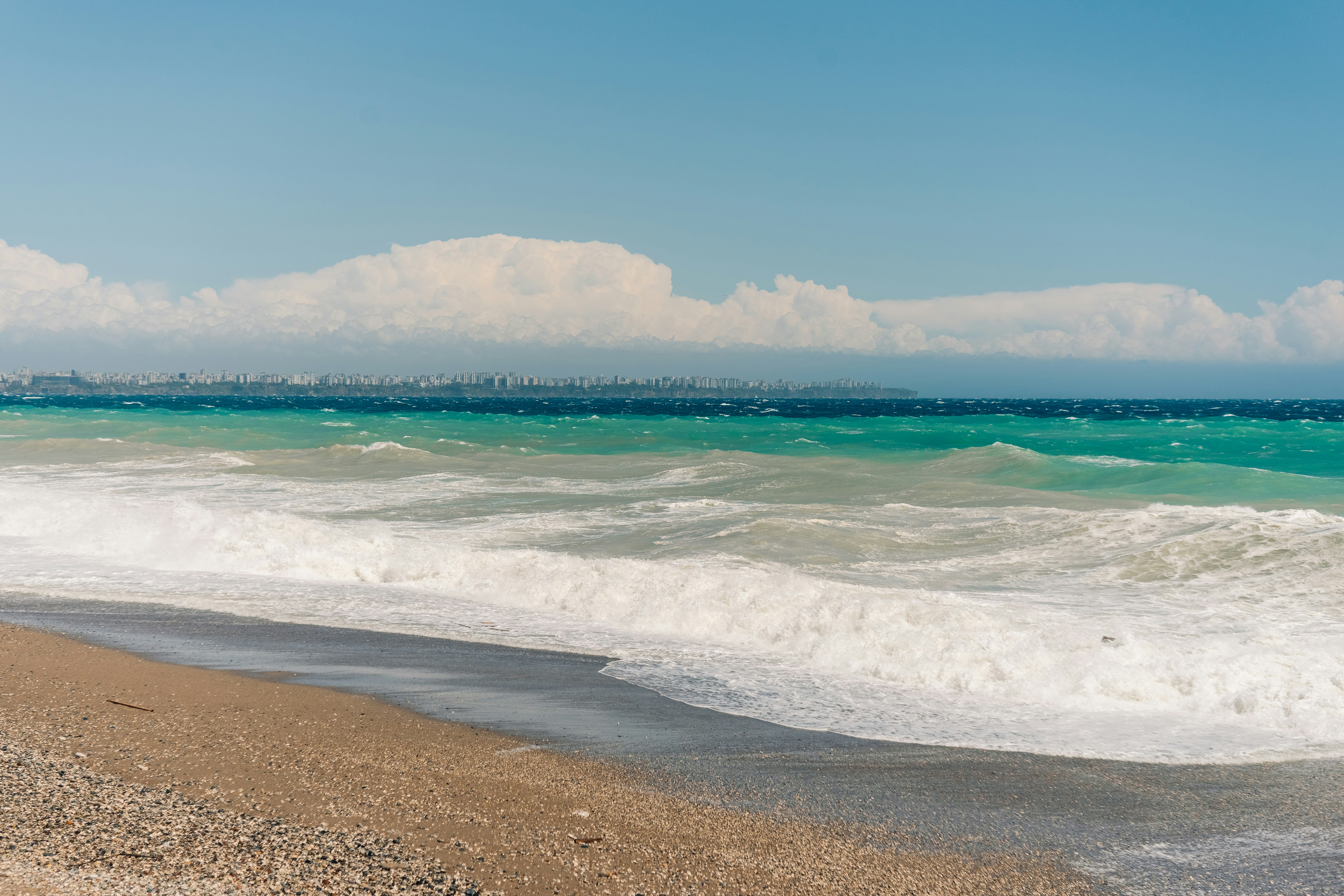 Sandy beach in Antalya with waves rolling in