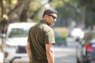 A man walking down a street with a skateboard