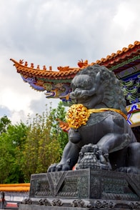 A statue of a lion in front of a building