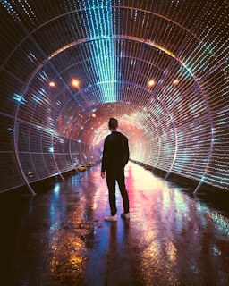 A man standing in a tunnel of lights