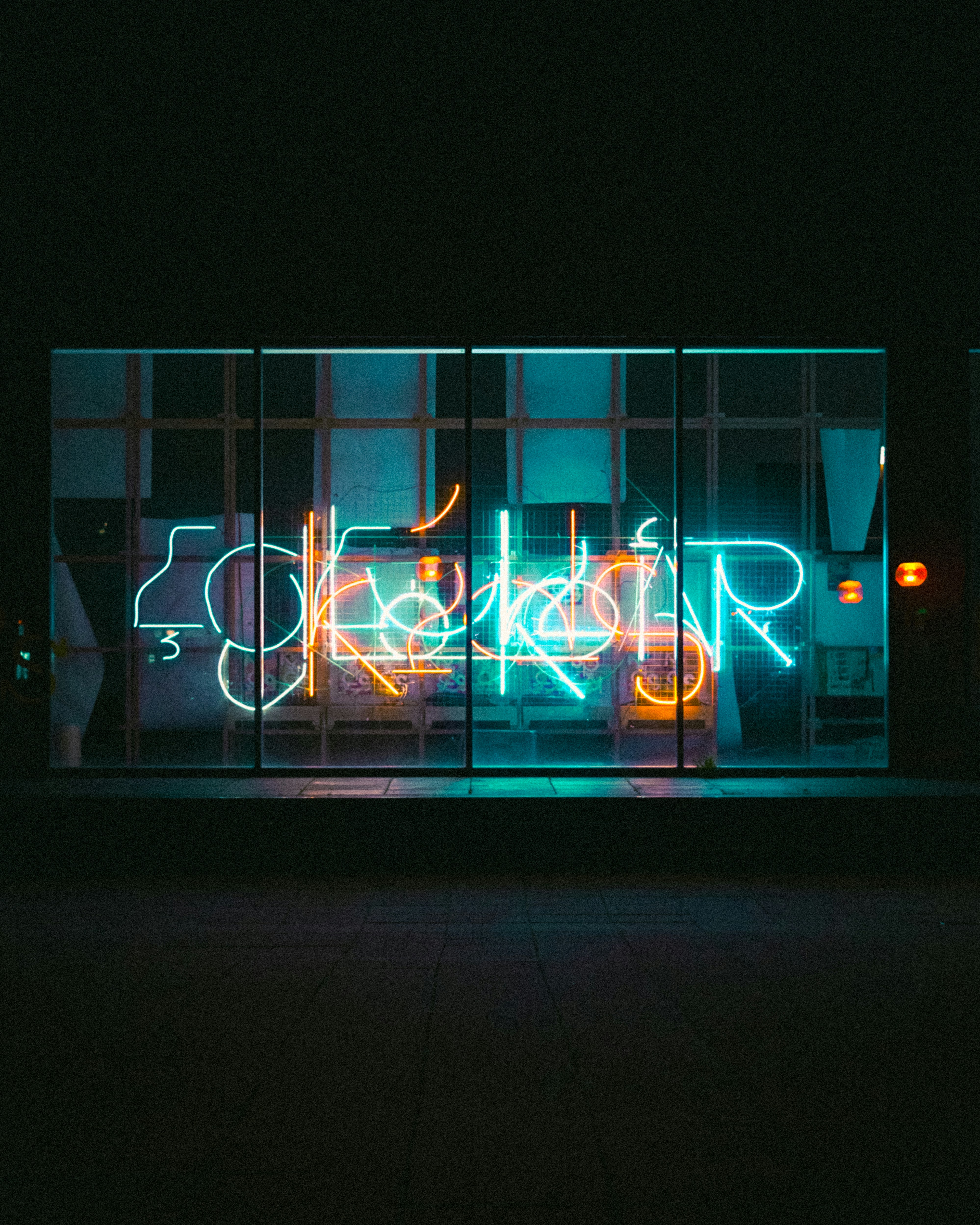 A neon sign that is on the side of a building