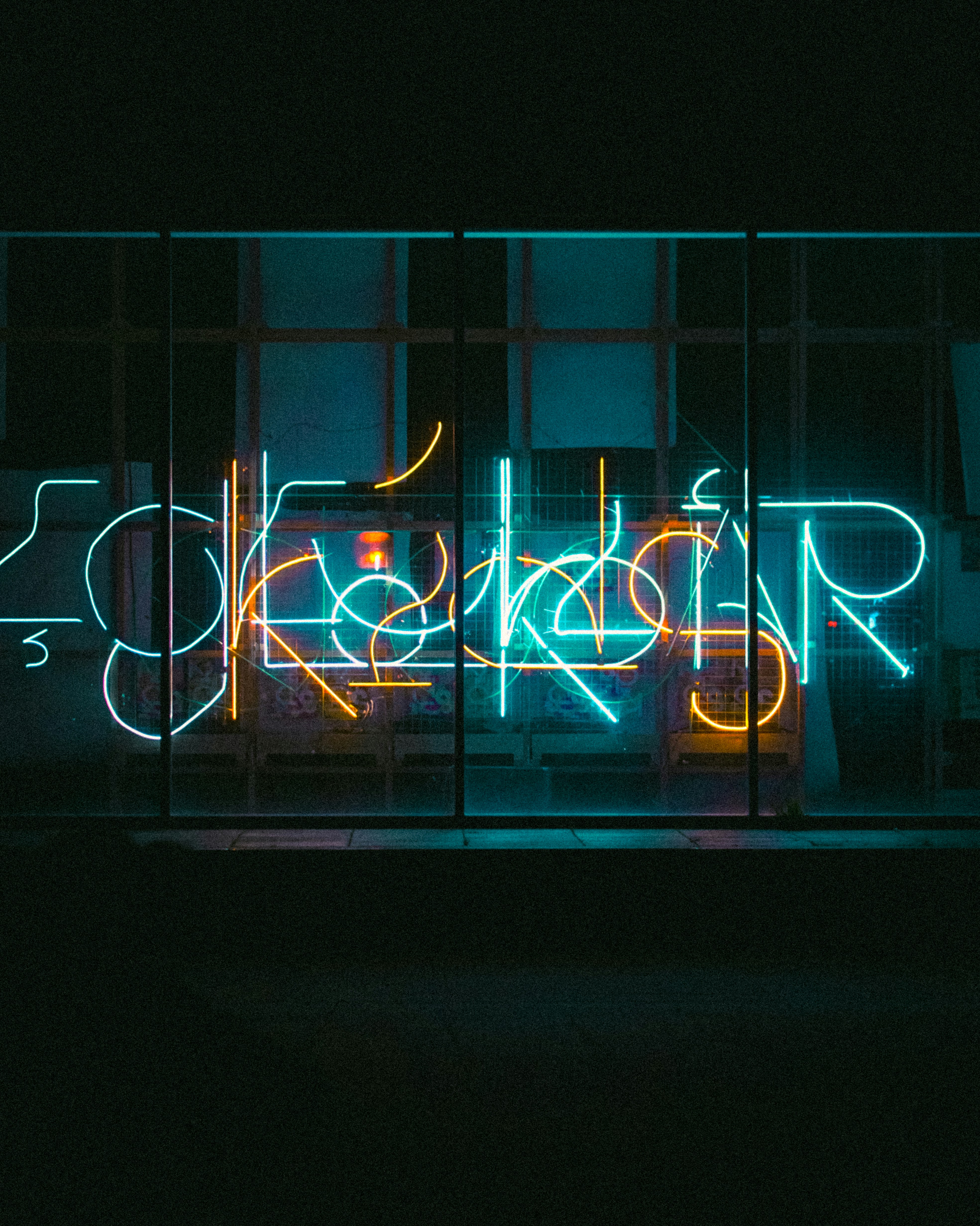 A neon sign that is on the side of a building