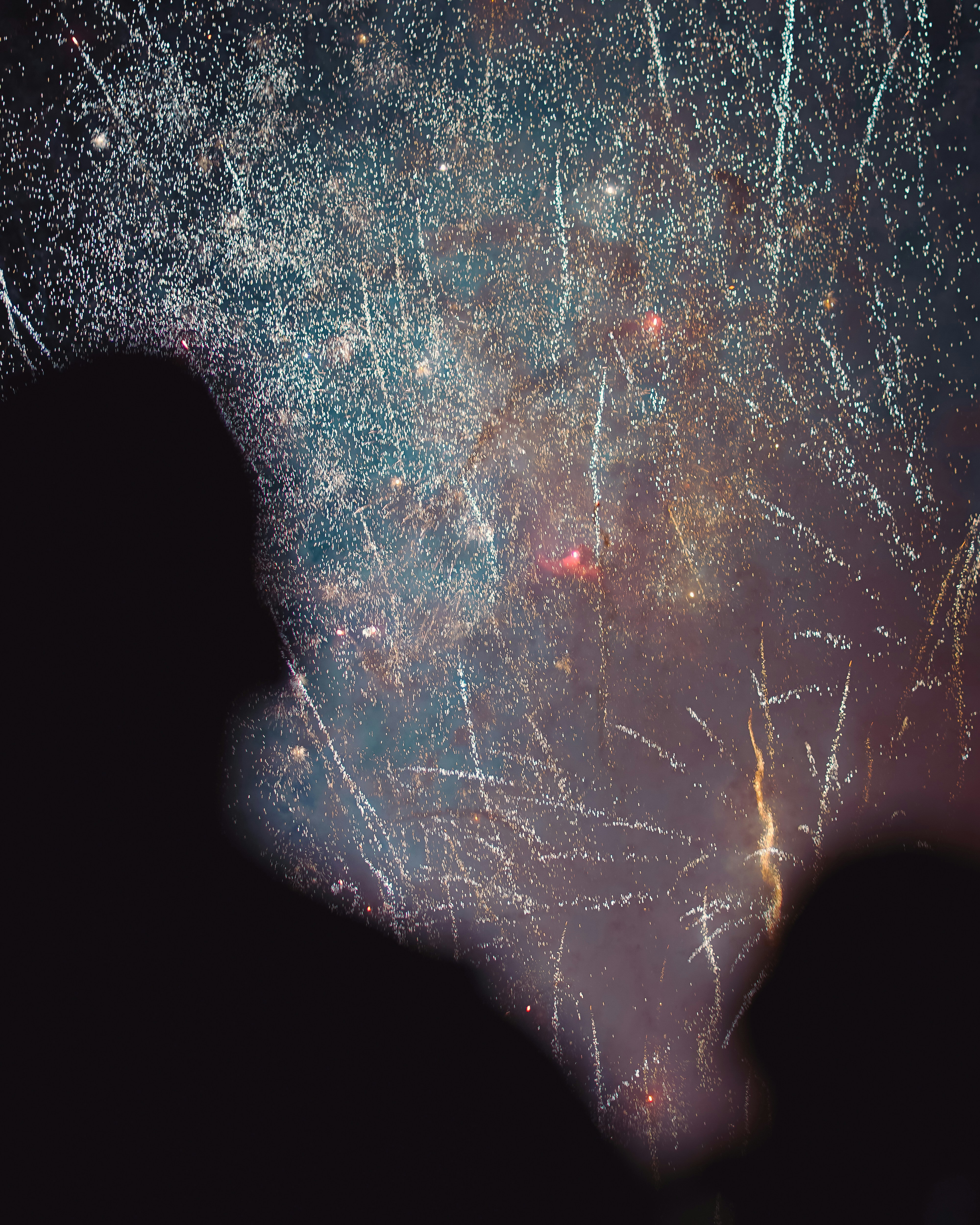 A person standing in front of a firework display