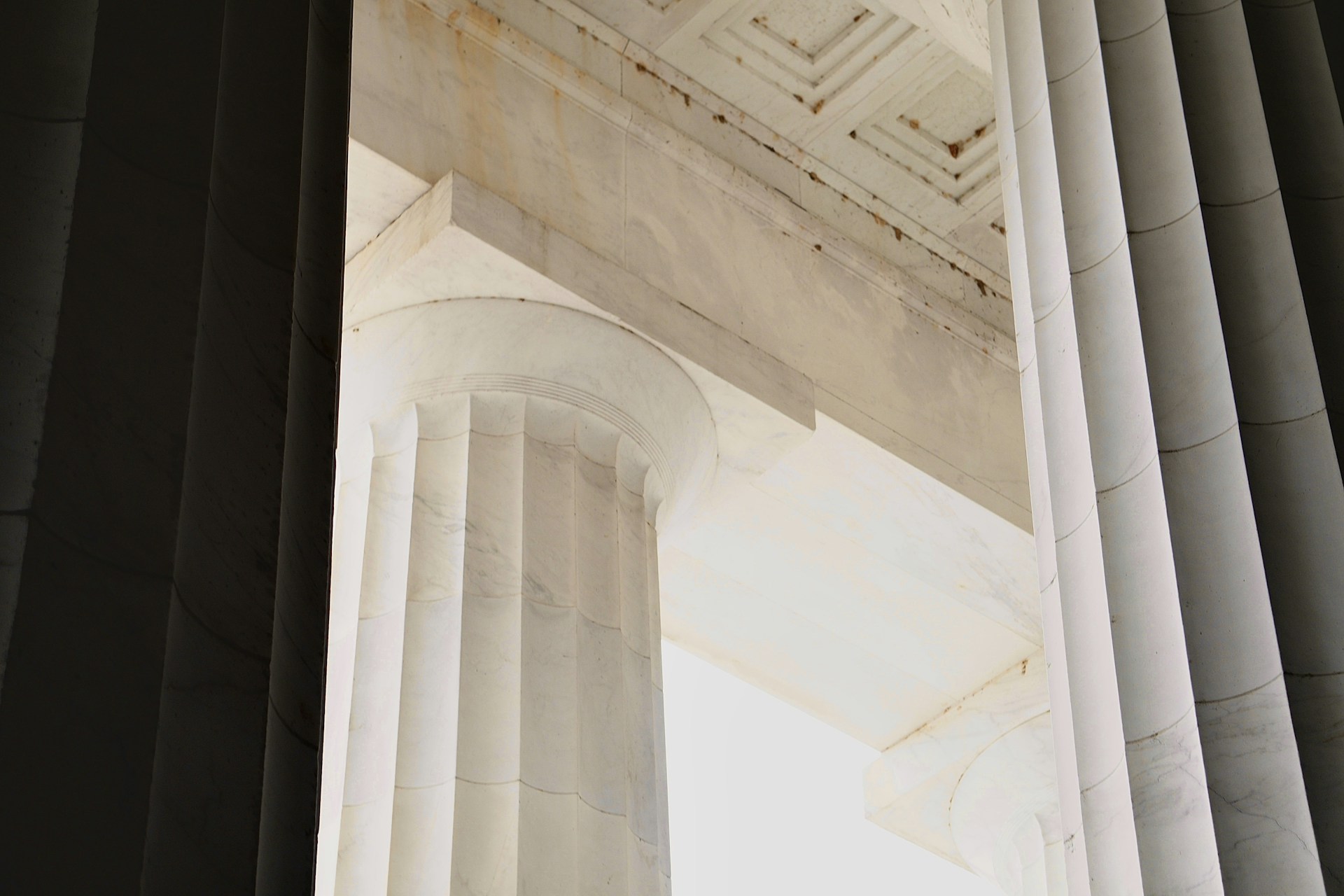 A tall column with a clock on top of it