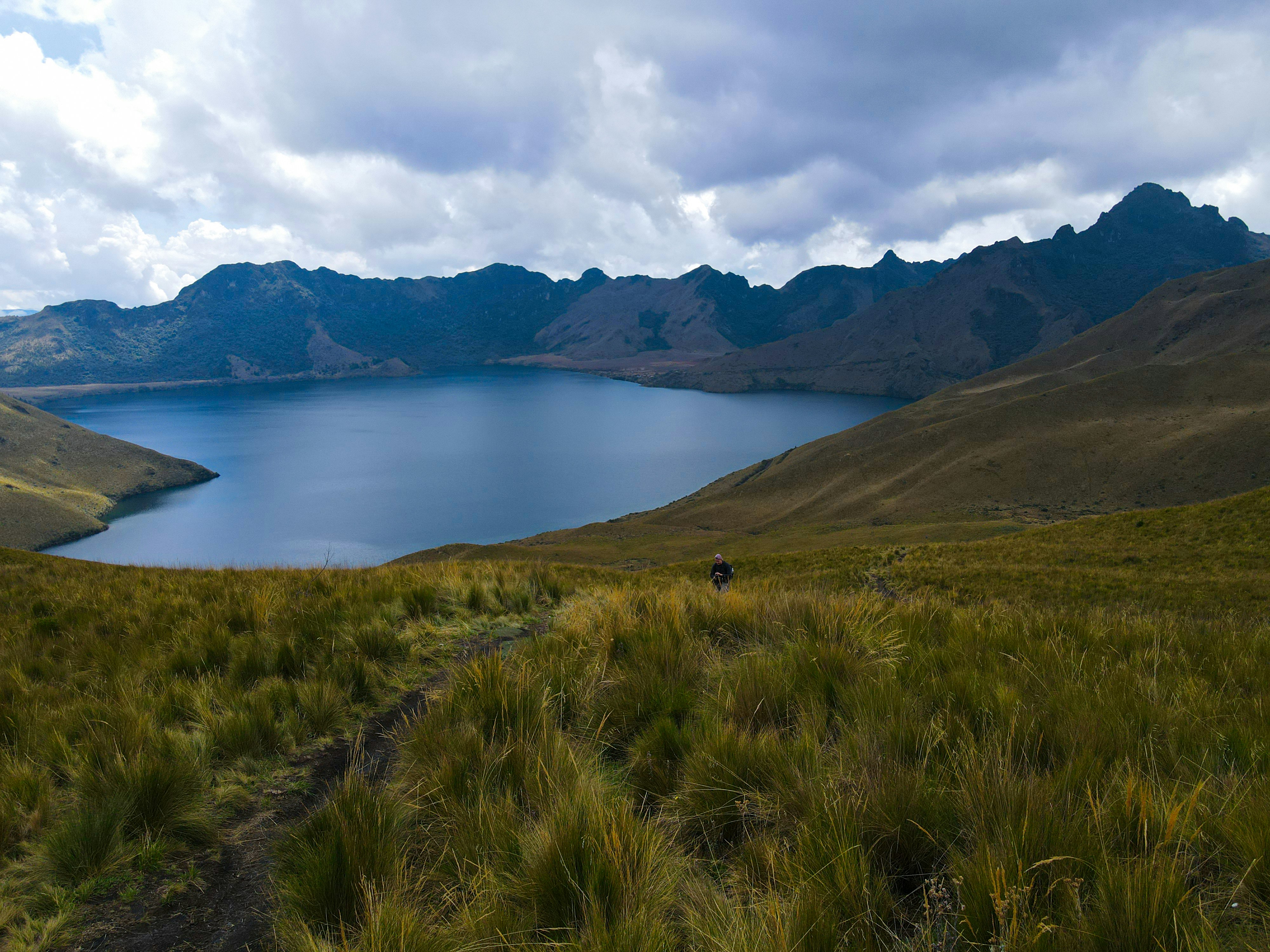 A large body of water surrounded by mountains - Otavalo