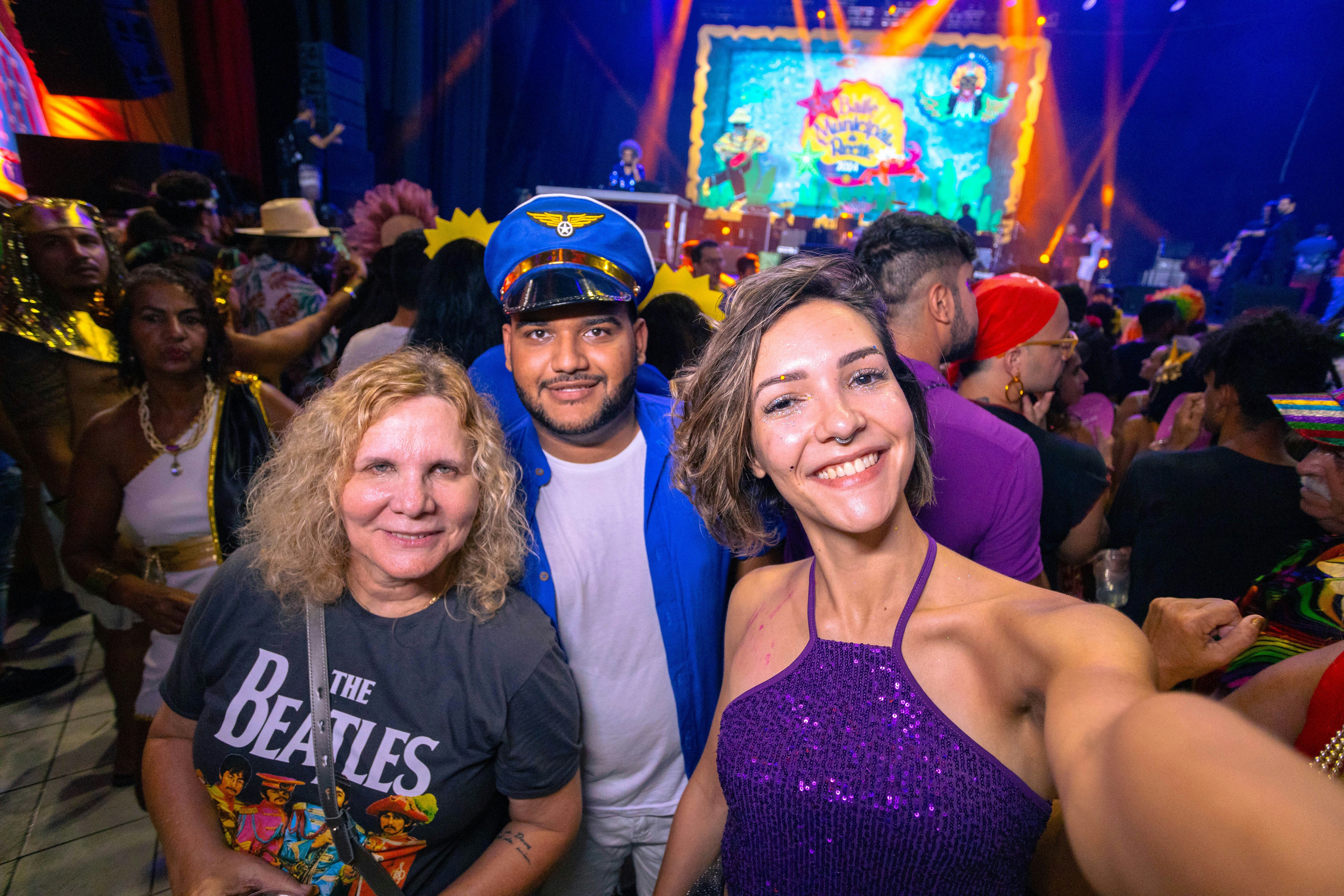 Vibrant event photography showing crowd at a celebration with colourful lights