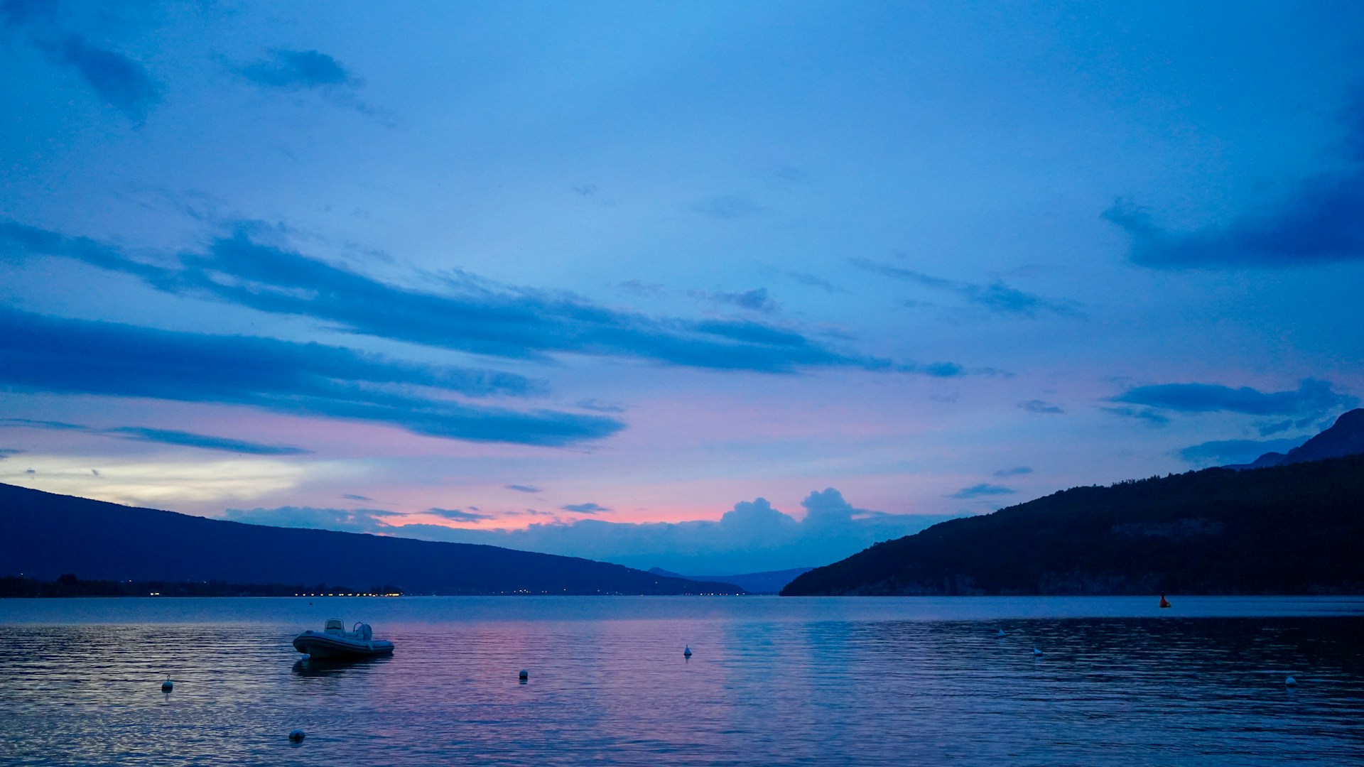 A boat floating on top of a large body of water