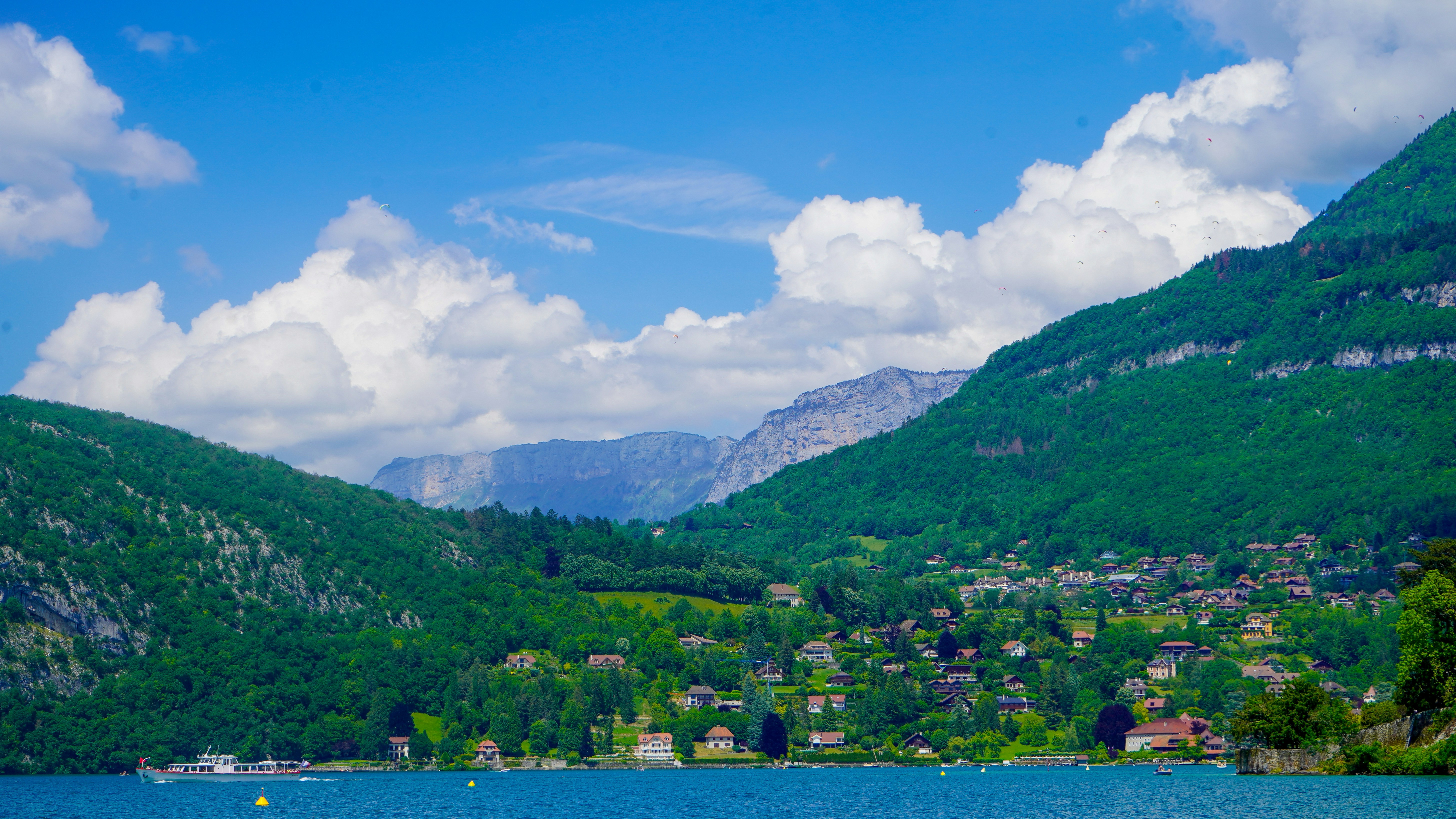 A body of water surrounded by mountains and trees