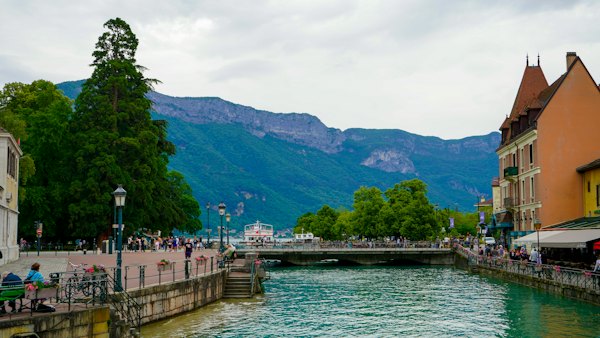 A river running through a city next to tall buildings — Annecy, France