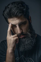 A man with a beard and a black shirt