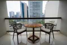 Two chairs and a table on a balcony