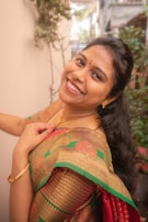 A woman in a sari smiling for the camera