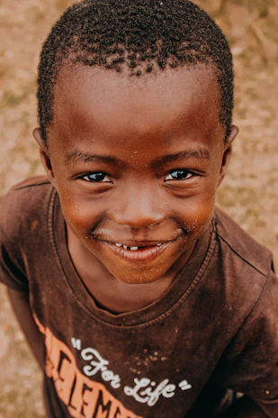 A young boy with a moustache on his face