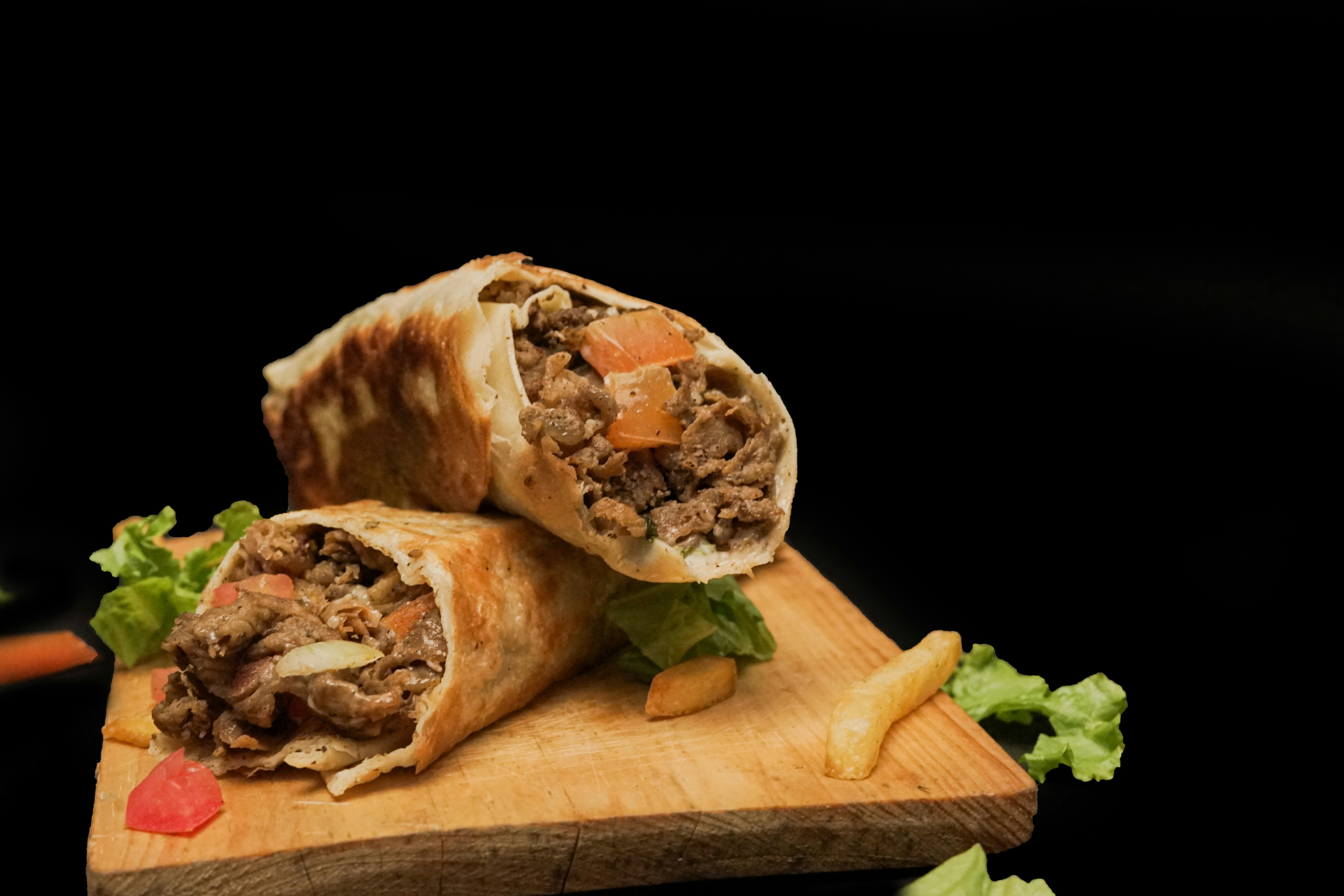 A cut in half sandwich sitting on top of a cutting board