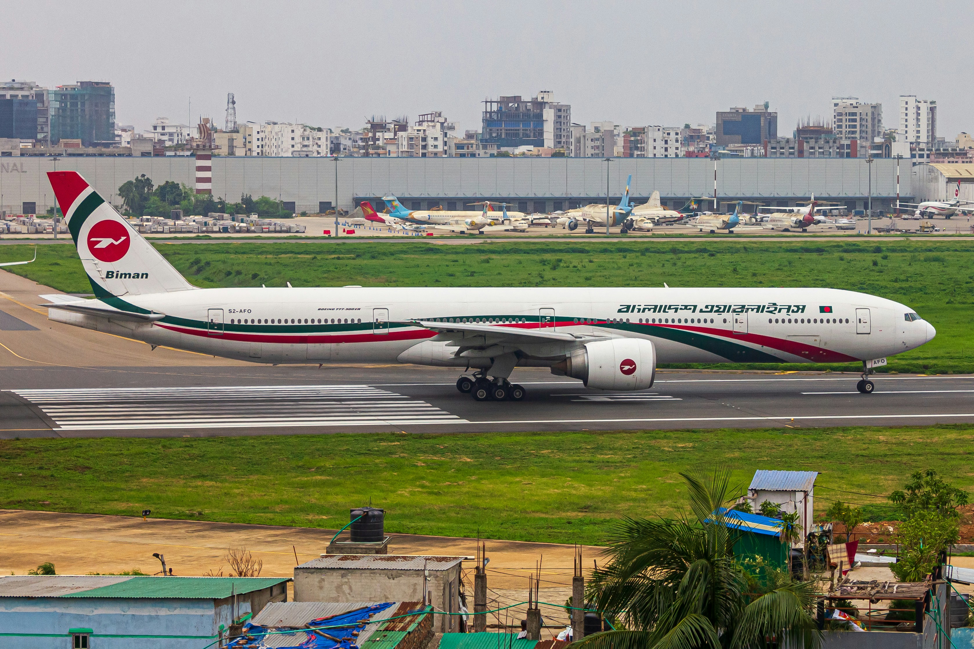 A large jetliner sitting on top of an airport runway, BIMAN BANGLADESH B77W PALKI 💥