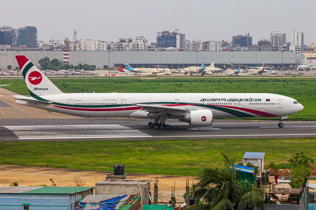 A large jetliner sitting on top of an airport runway, BIMAN BANGLADESH B77W PALKI 💥
