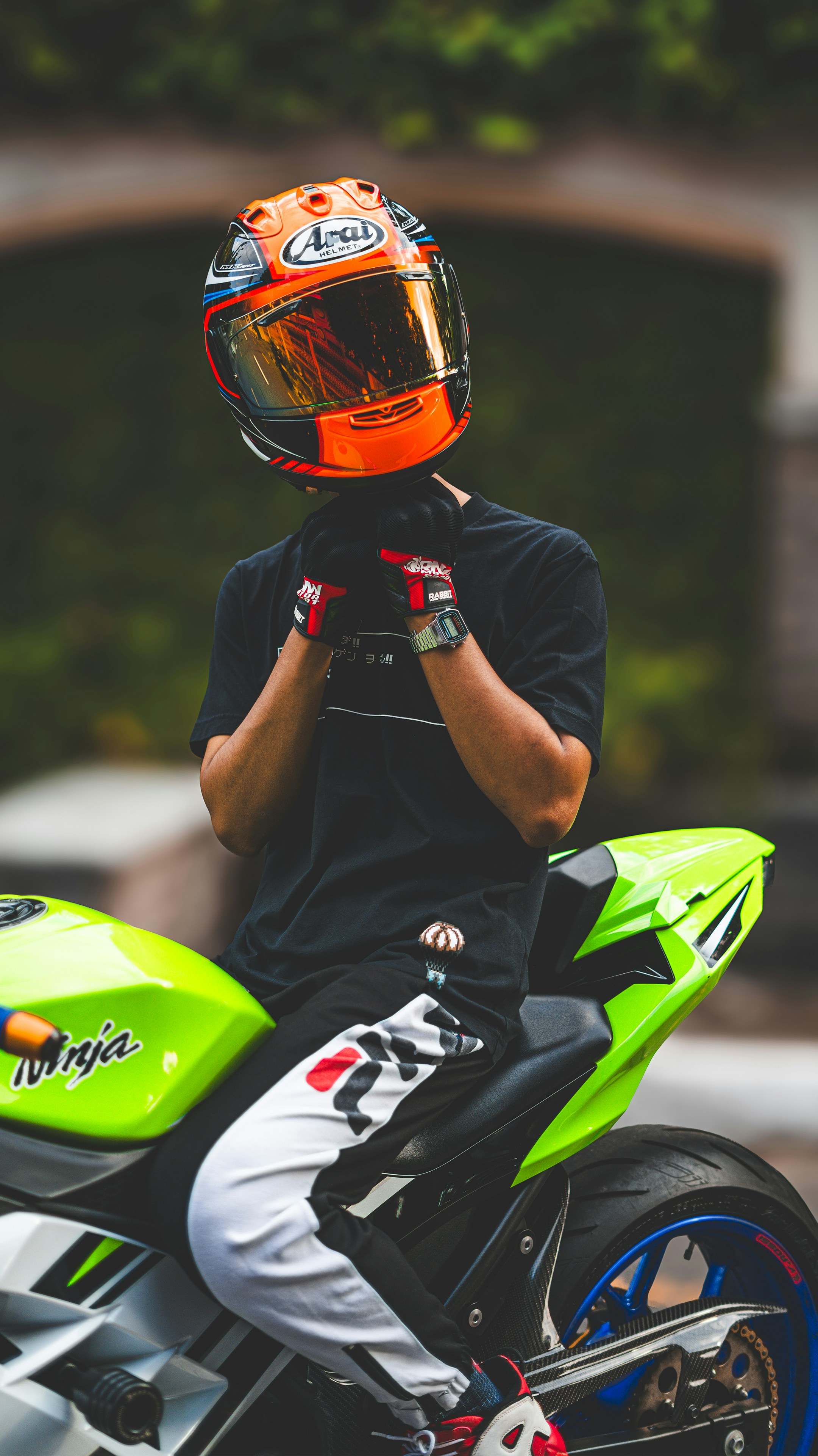 A person sitting on a motorcycle with a helmet on