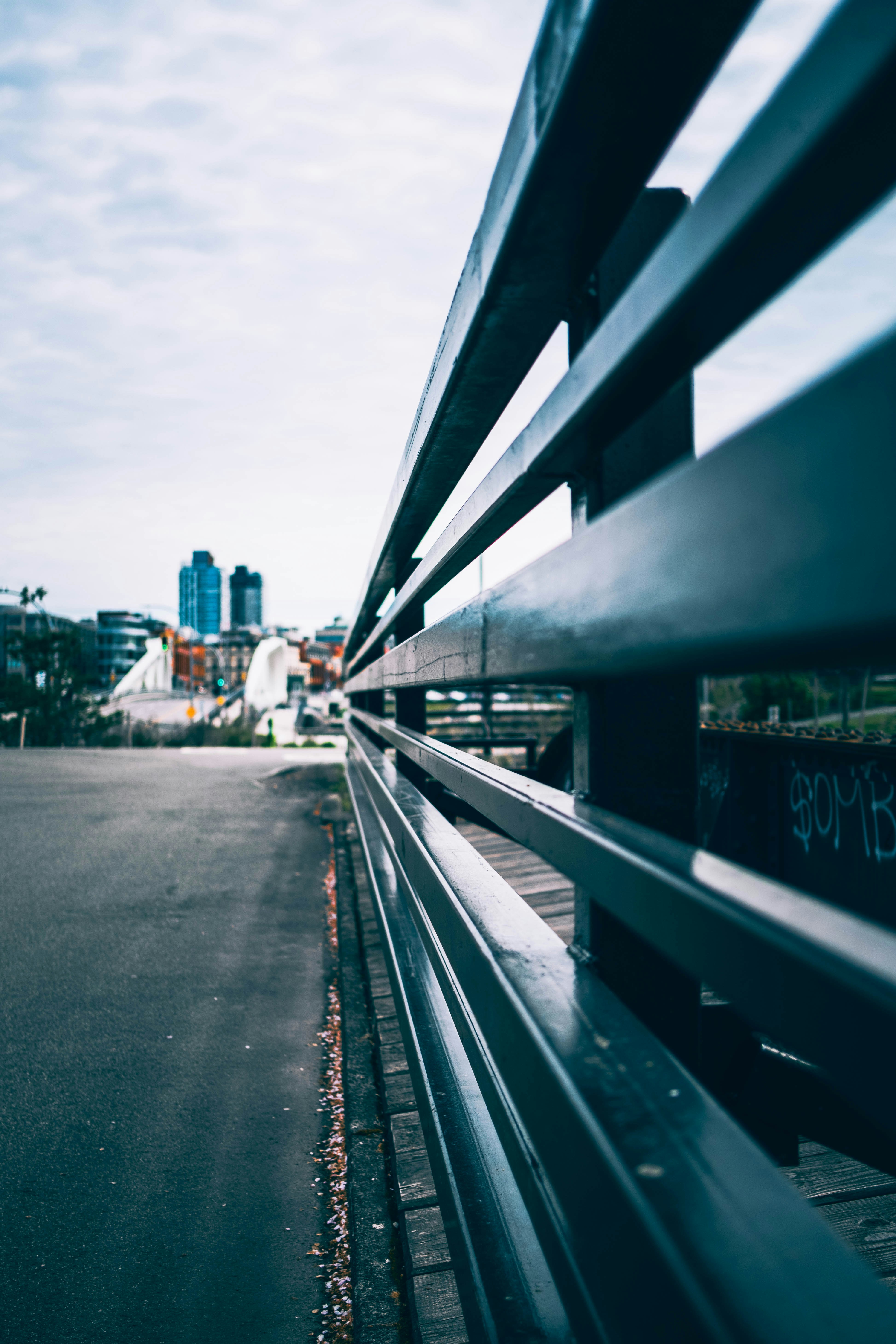 A bench sitting on the side of a road