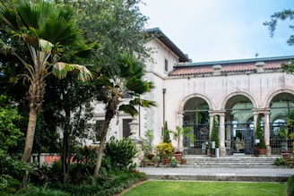 A large house with a lot of trees and bushes