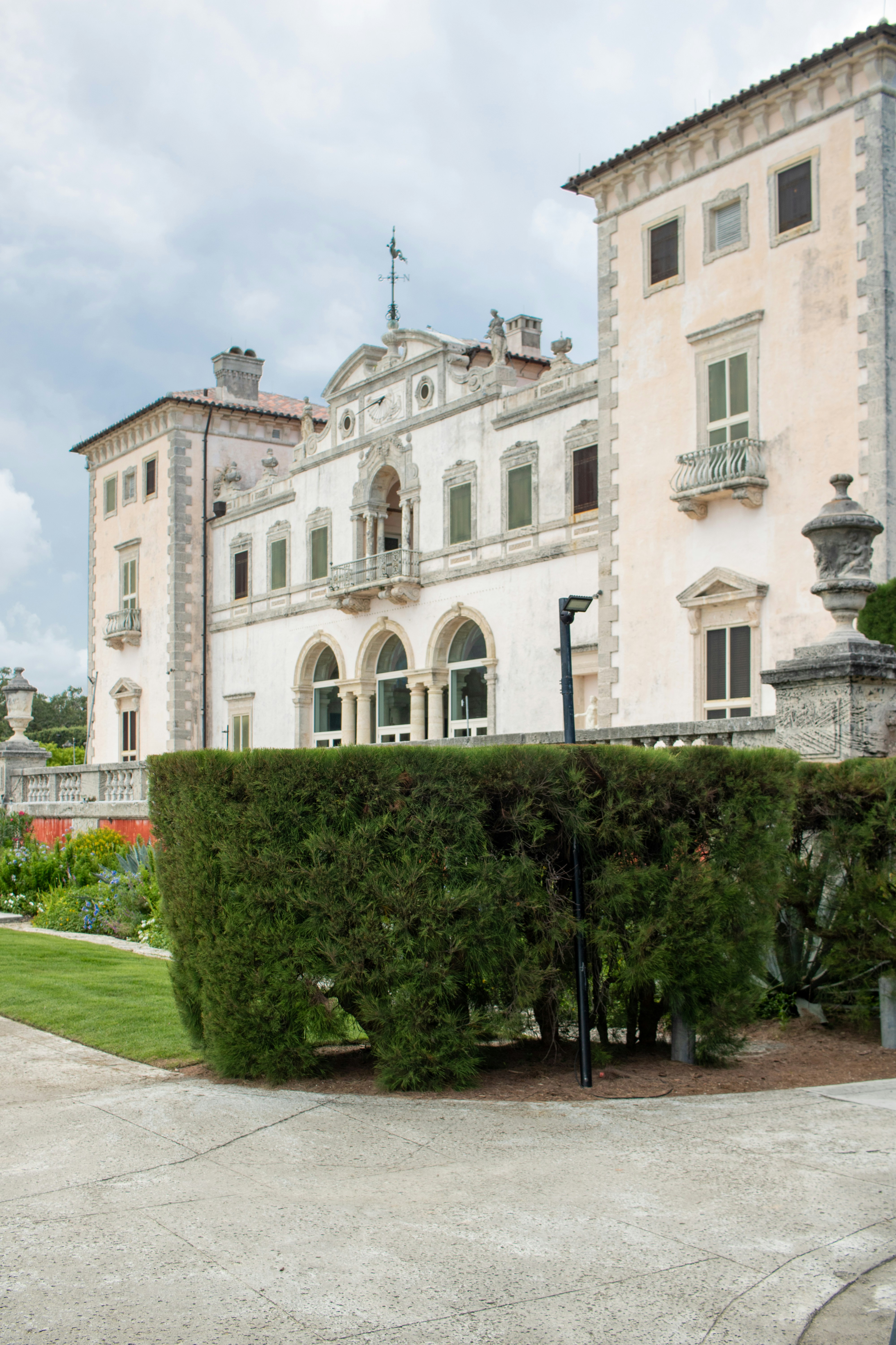 A large white building with a fountain in front of it