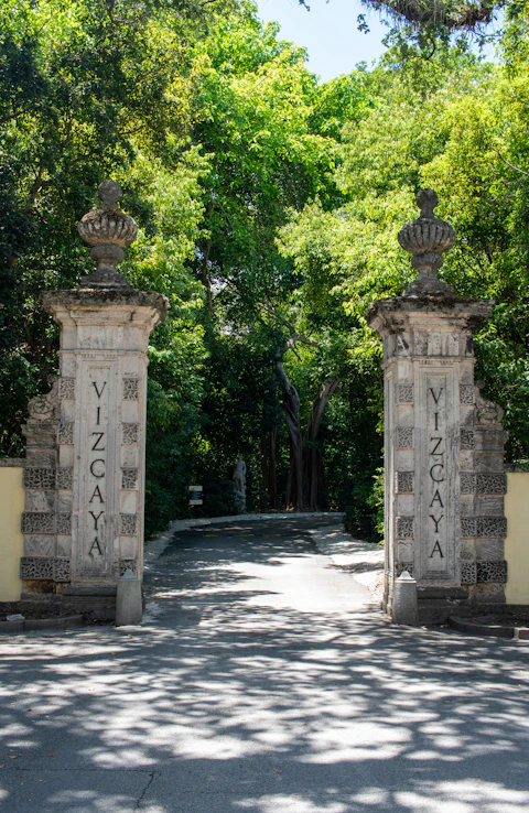 Gate entrance to Vizcaya Museum and Gardens that are on the side of a road