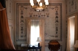 A bedroom with a chandelier hanging from the ceiling