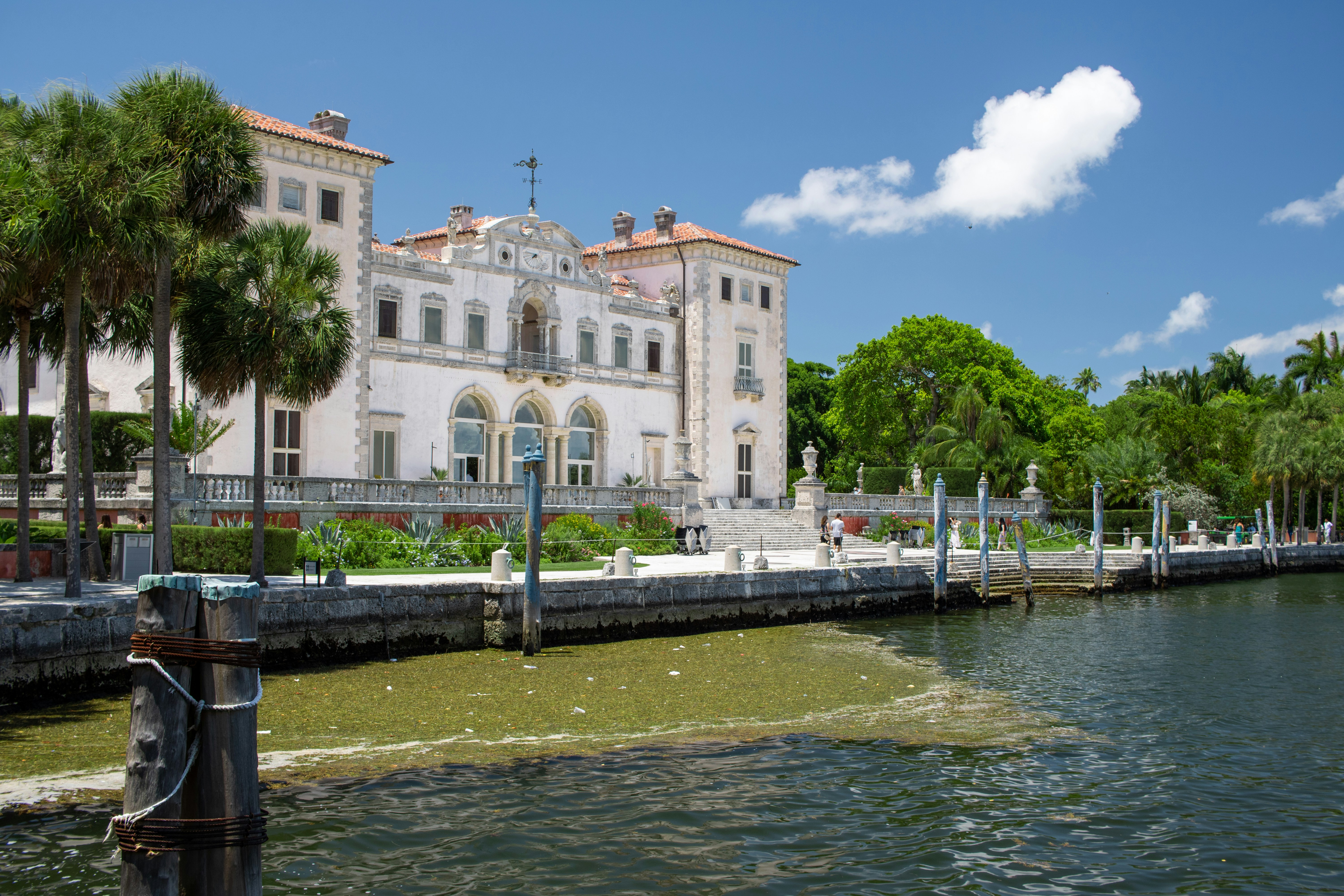 A large white building sitting next to a body of water