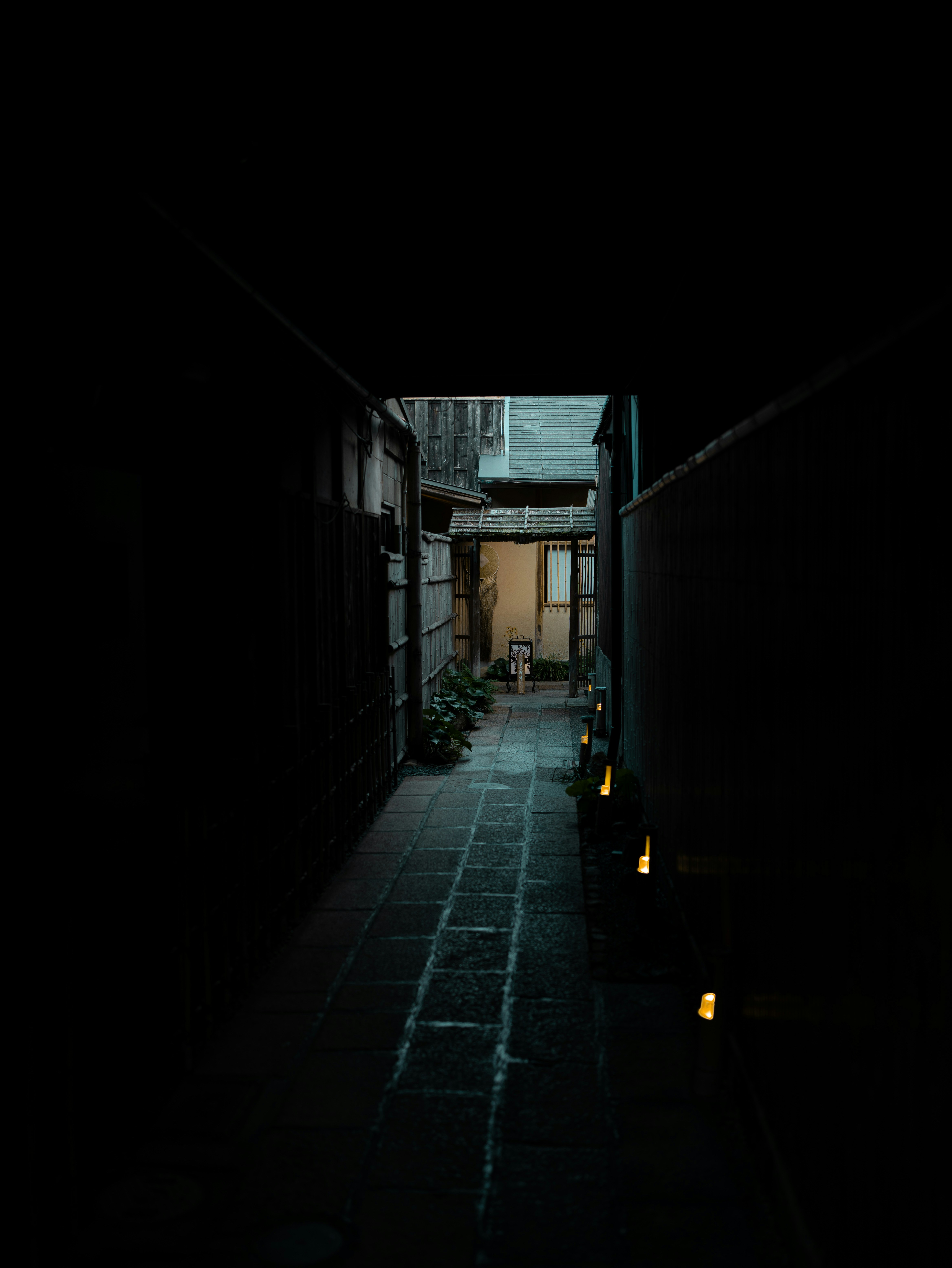 Kyoto traditional geisha district at night, dark lantern-lit stone alley, moody amber lantern glow on wooden facades, deep shadow atmospheric
