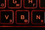 A close up of a keyboard with a red light