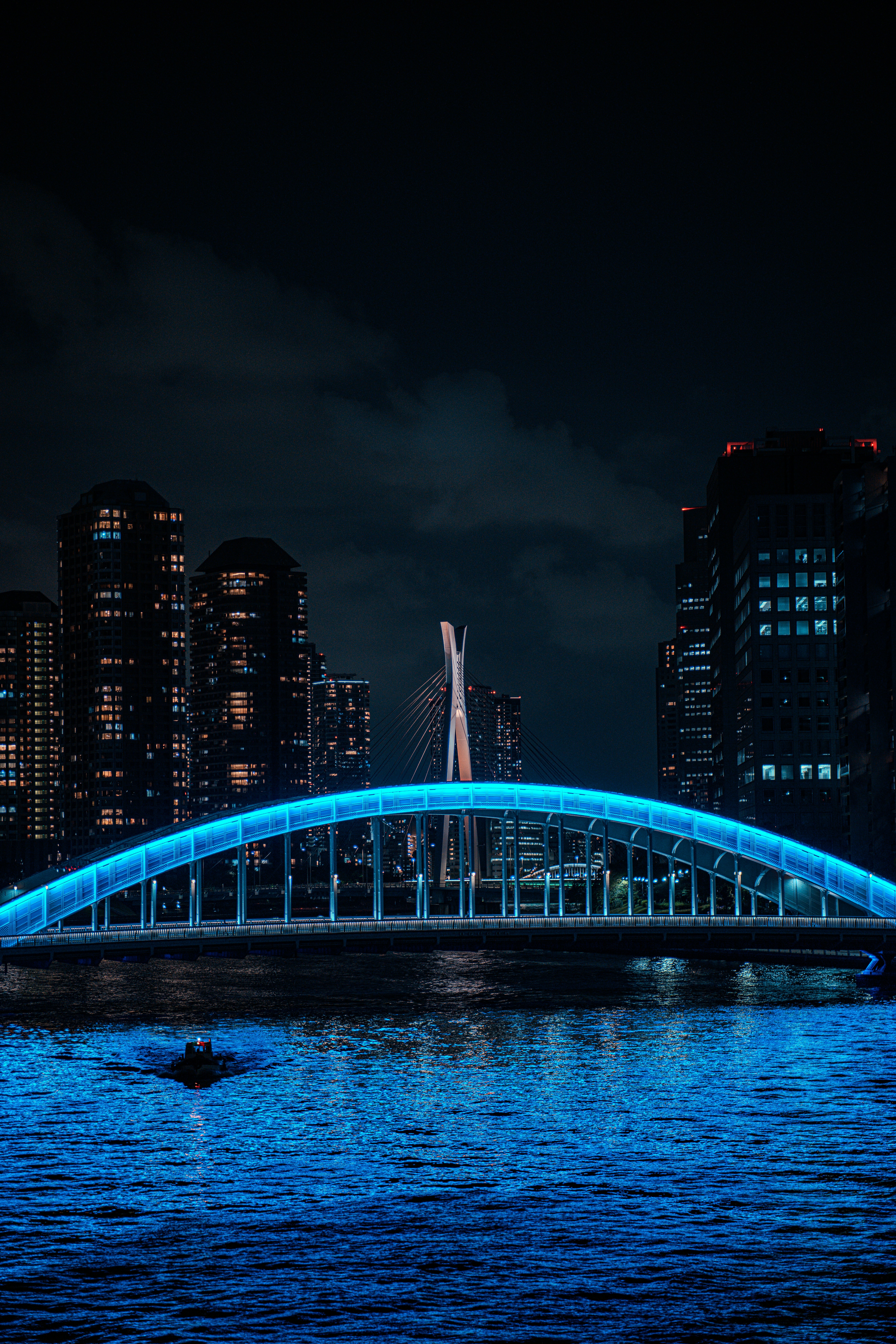 A large bridge over a body of water at night