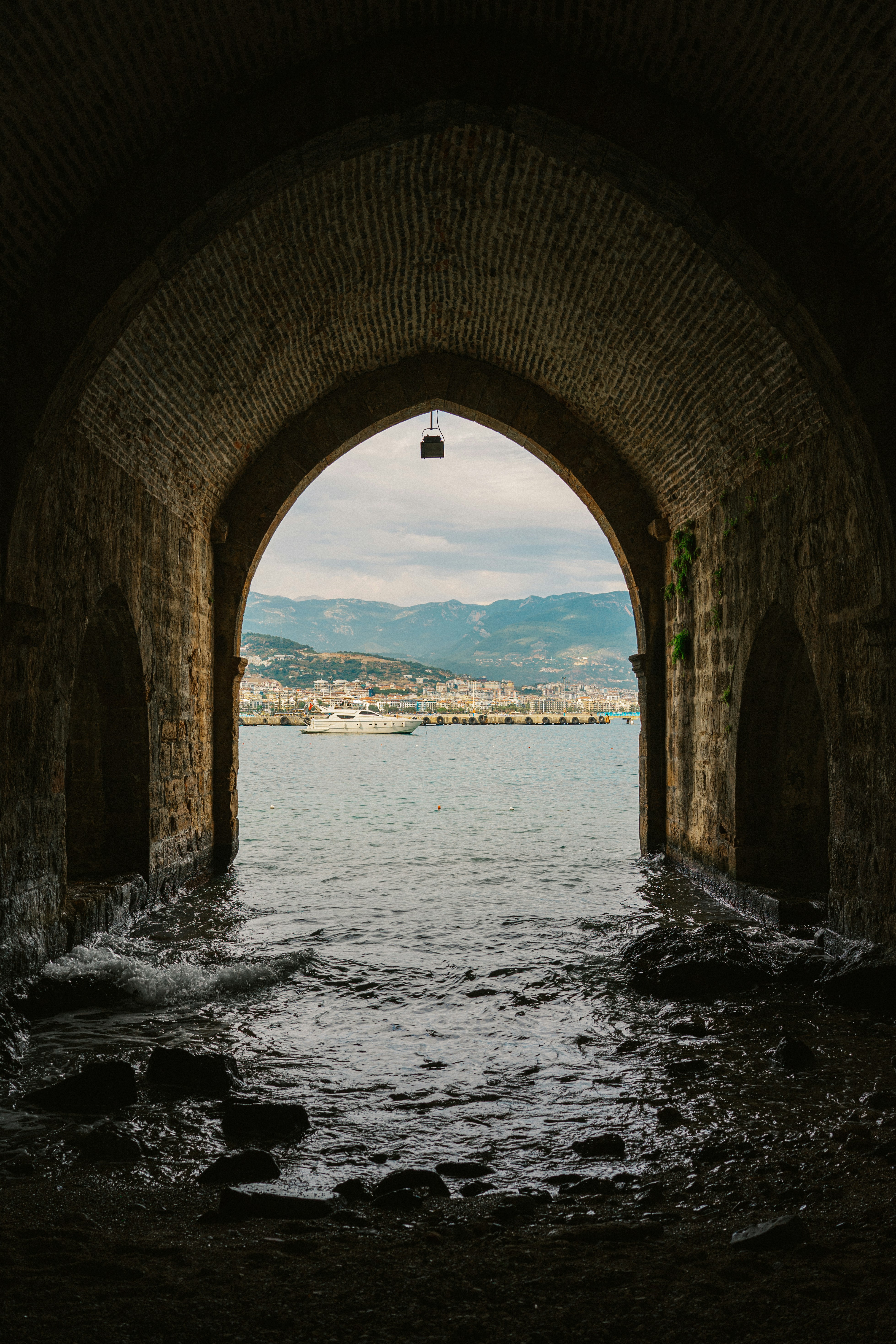 A view of a body of water through a tunnel