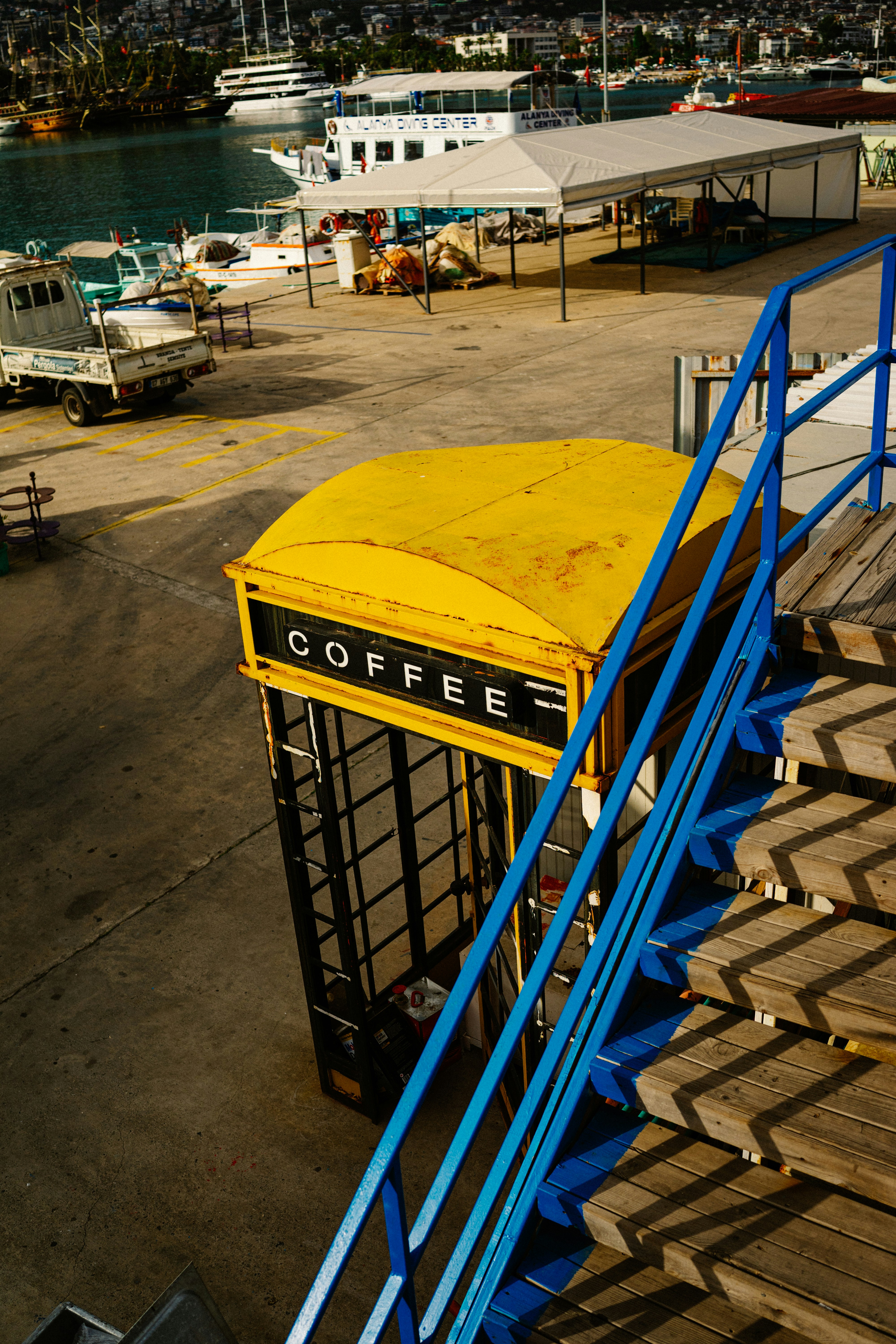A yellow coffee shop sitting on top of a dock