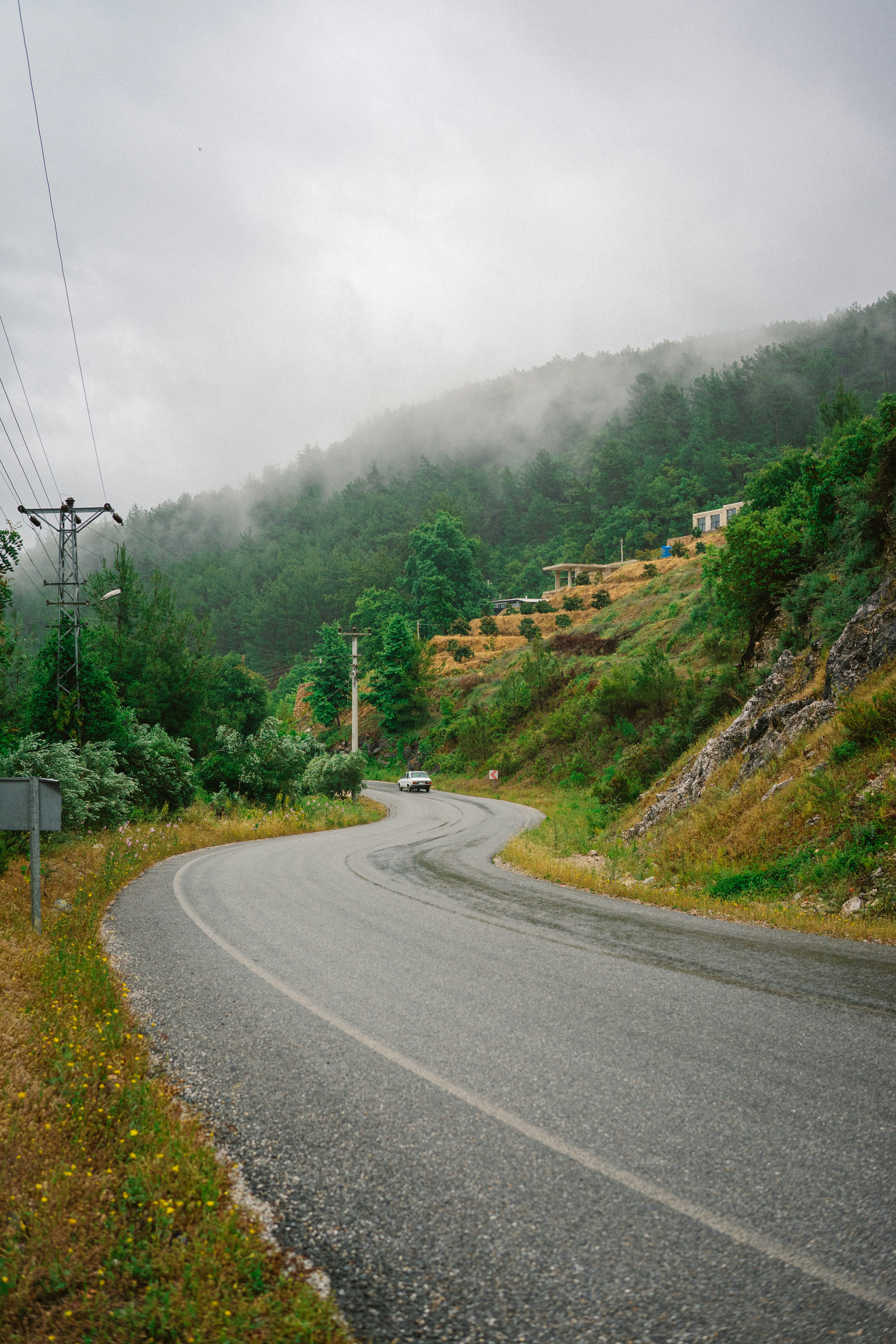 A car driving down a road in the mountains