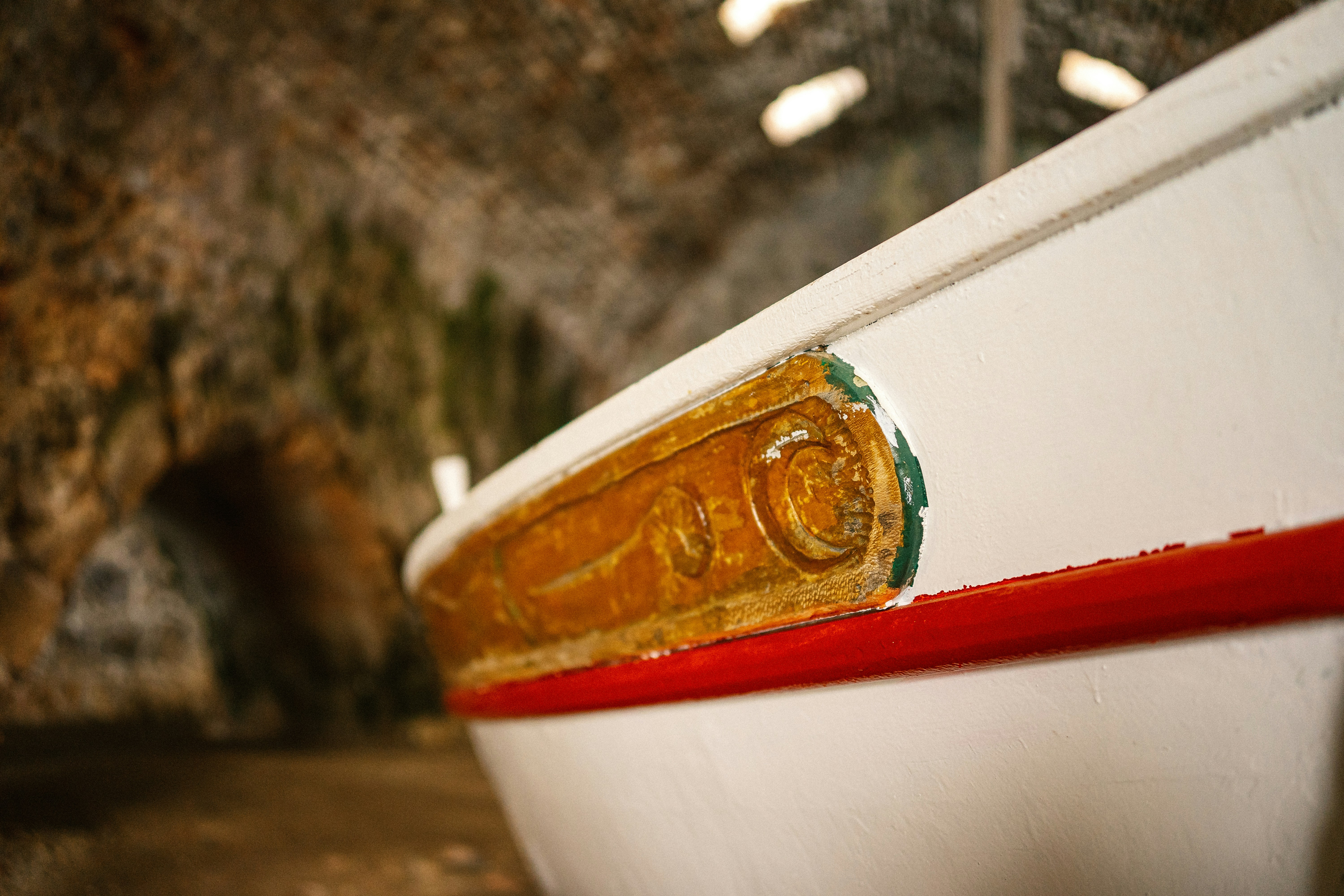 A close up of a white boat in a cave