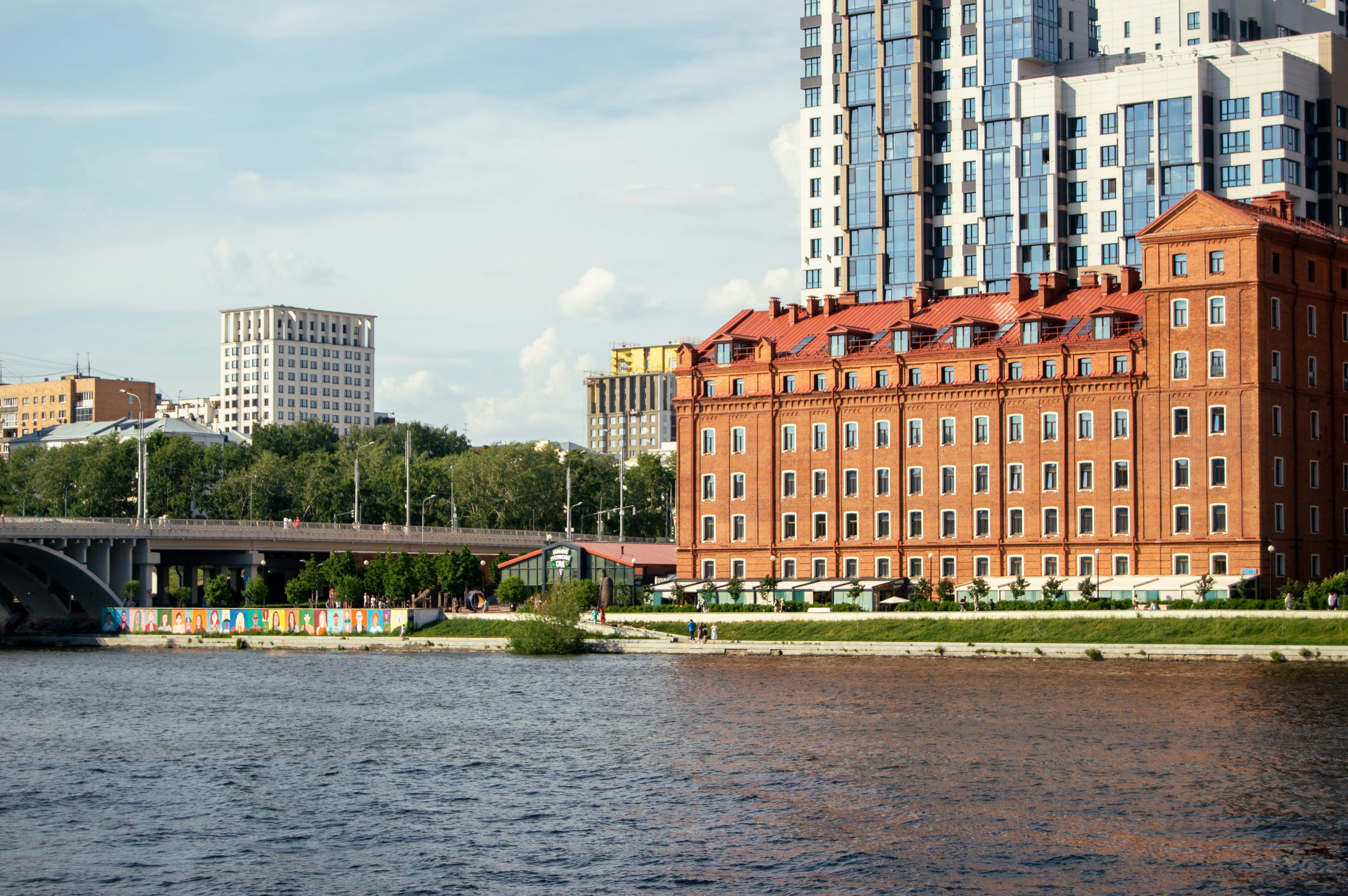 A river with a bridge and buildings in the background