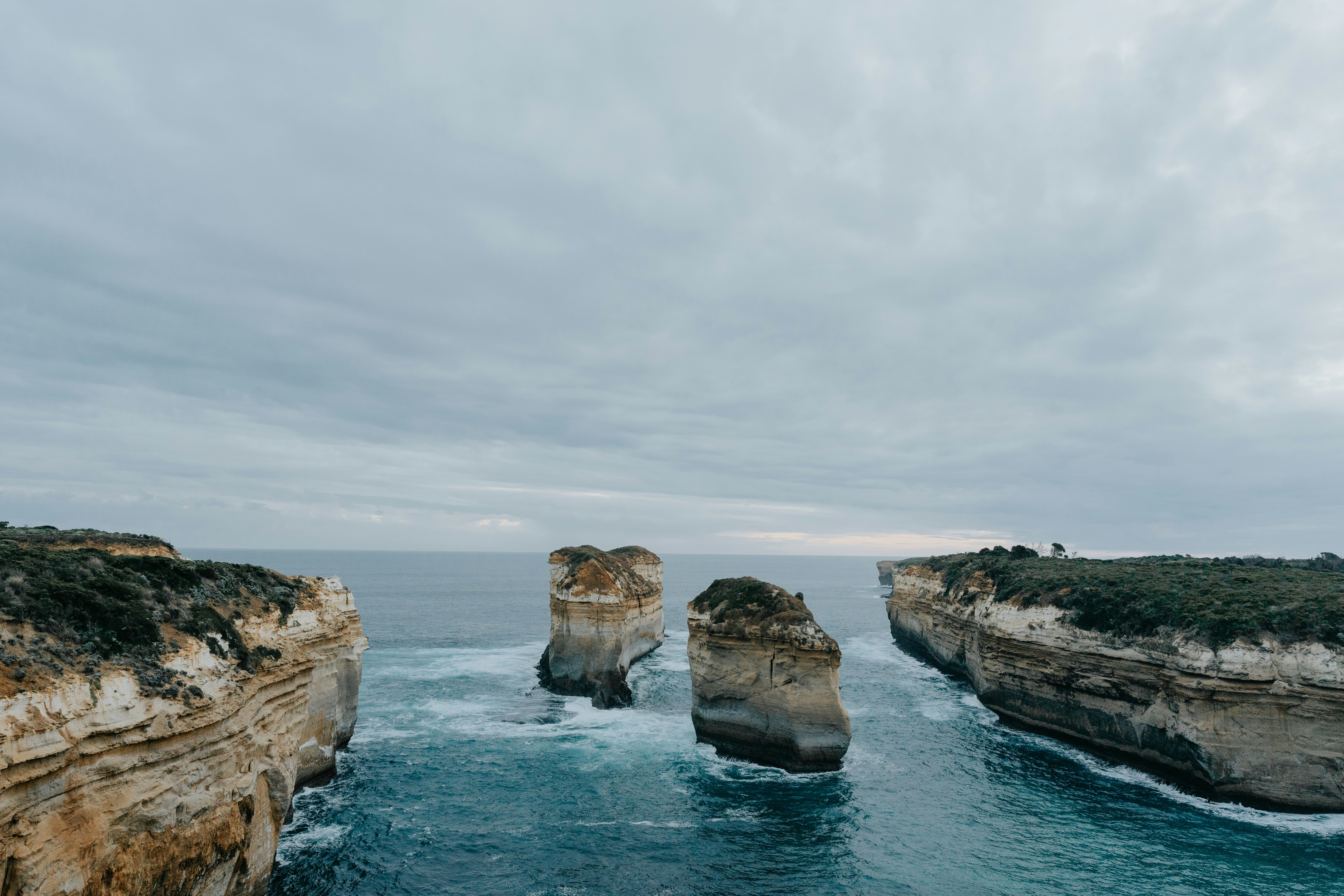 A view of a body of water with two large rocks sticking out of the water